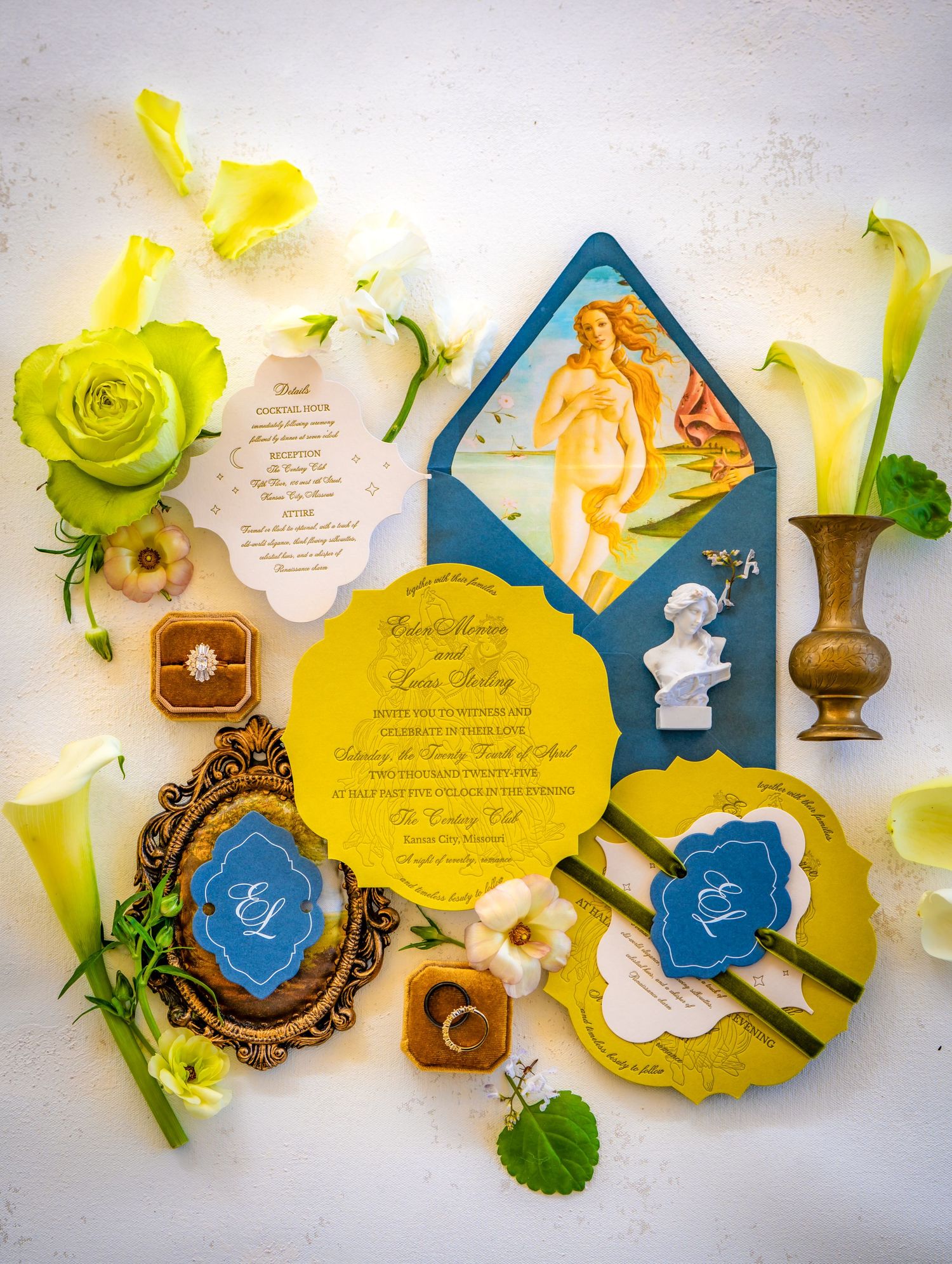 Wedding invitation suite in yellow and blue with floral accents and calligraphy details.