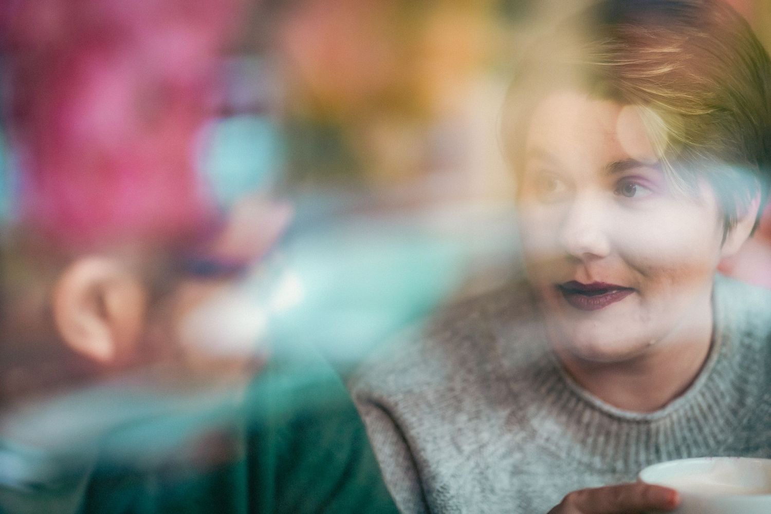 Candid coffee shop scene with soft bokeh lighting and warm tones.