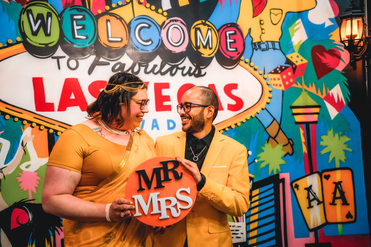 Festive backdrop with Las Vegas themed decorations and bright neon colors.