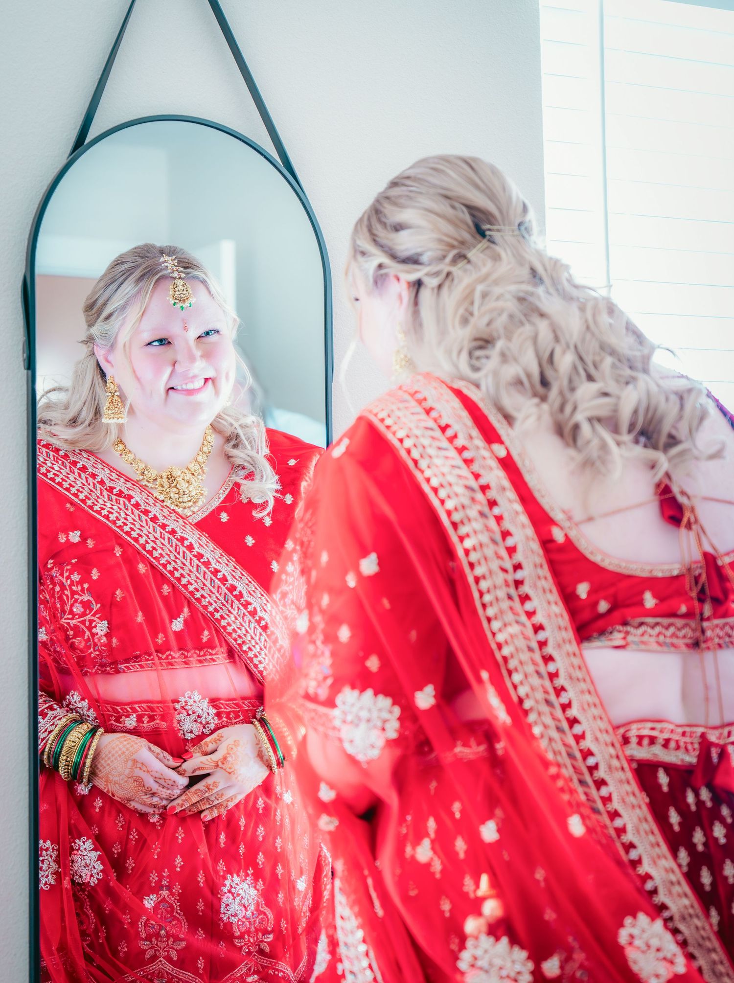 Series of reflections showing detailed embroidery on a bright red traditional dress.