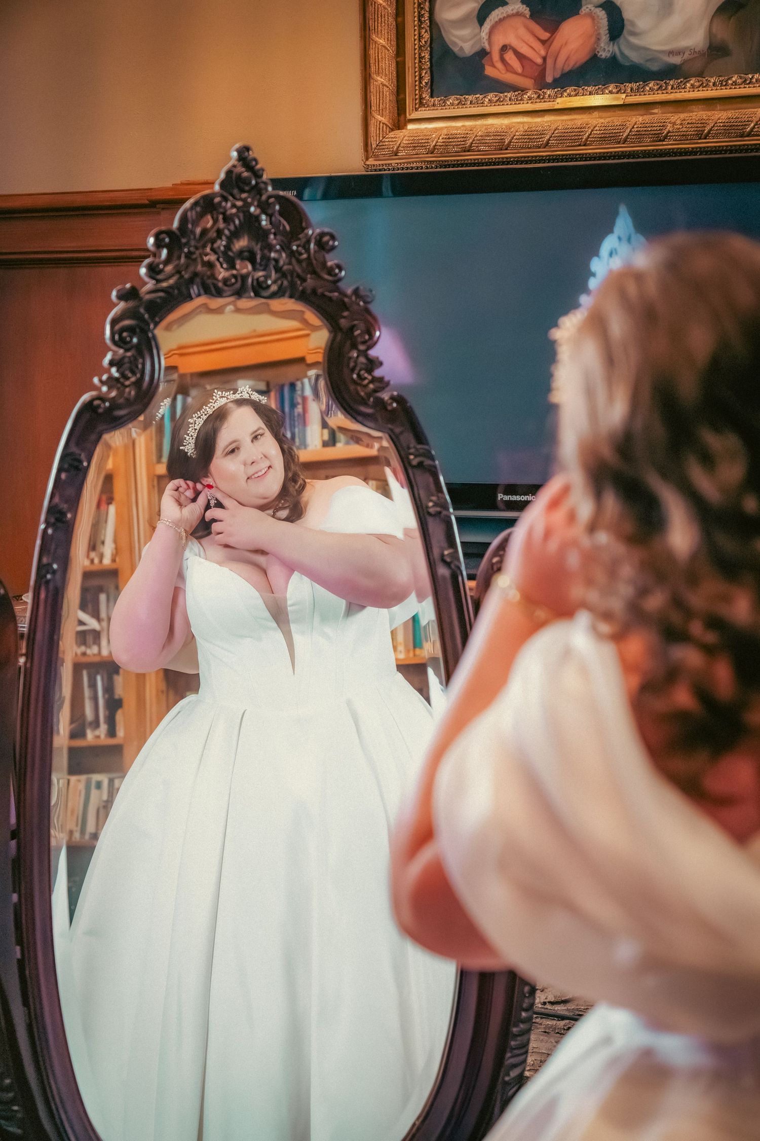 Vintage-style ornate mirror reflection showing wedding preparation moments.