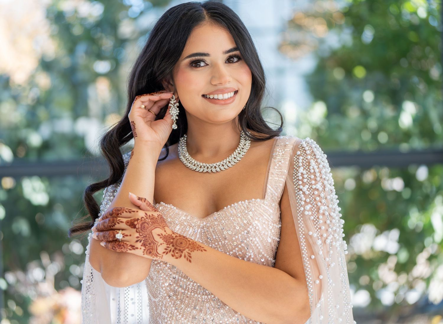 Bridal portrait featuring sparkly beaded dress and elegant jewelry.