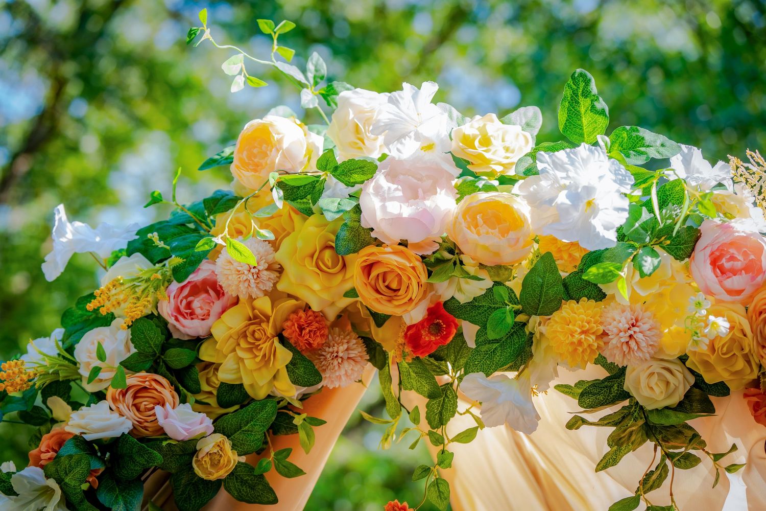 Elegant floral decoration with pink and yellow roses adorns the wedding venue.