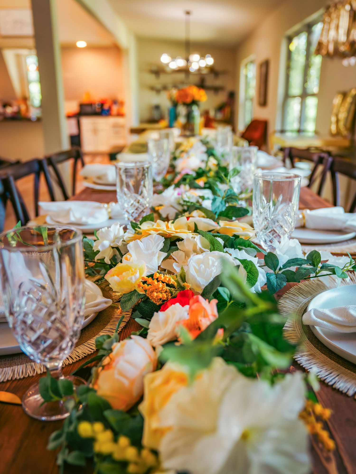 Elegant table setting with crystal glasses and floral centerpieces for a wedding reception.