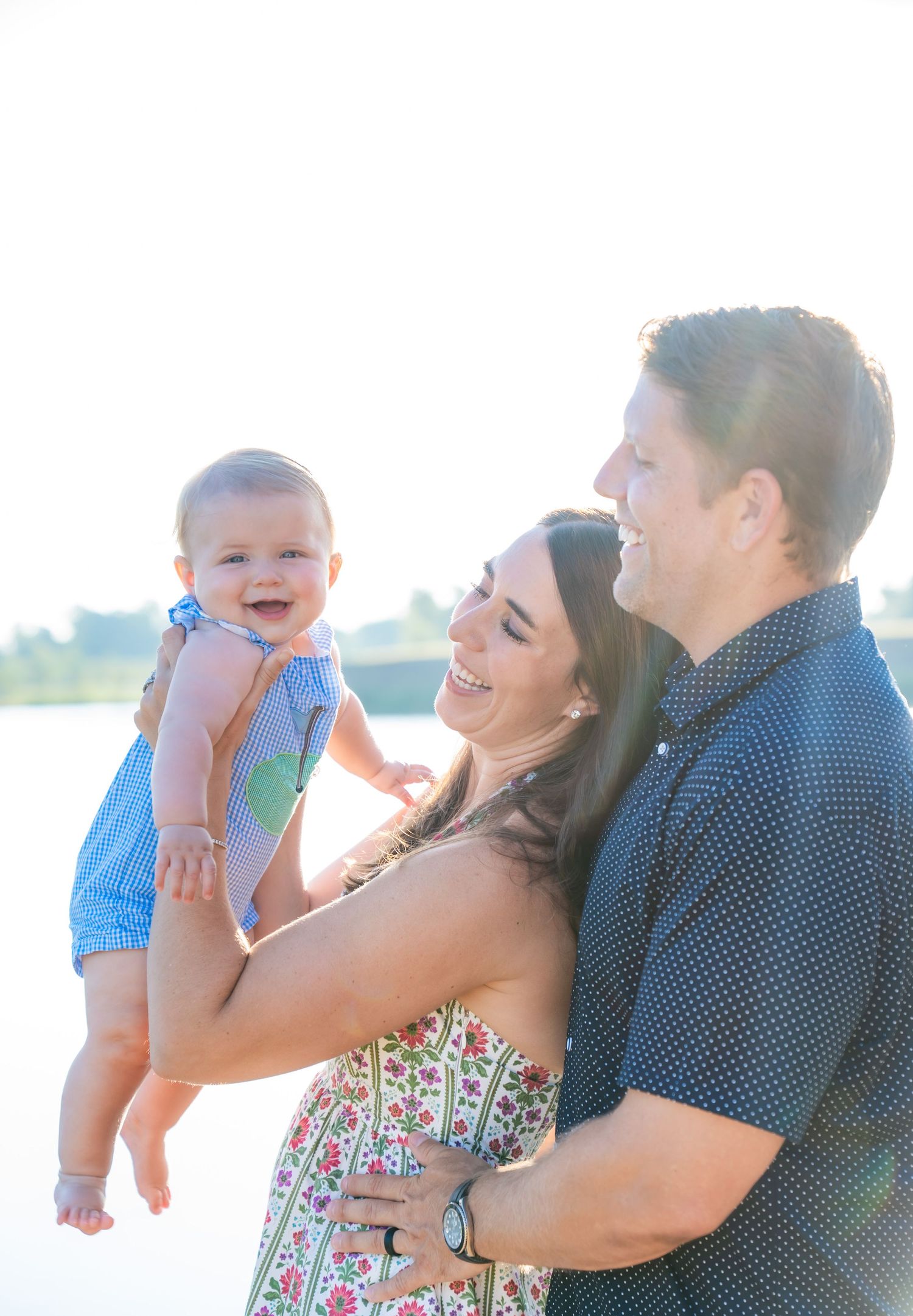 Happy outdoor family moment captured against bright sunlit background.