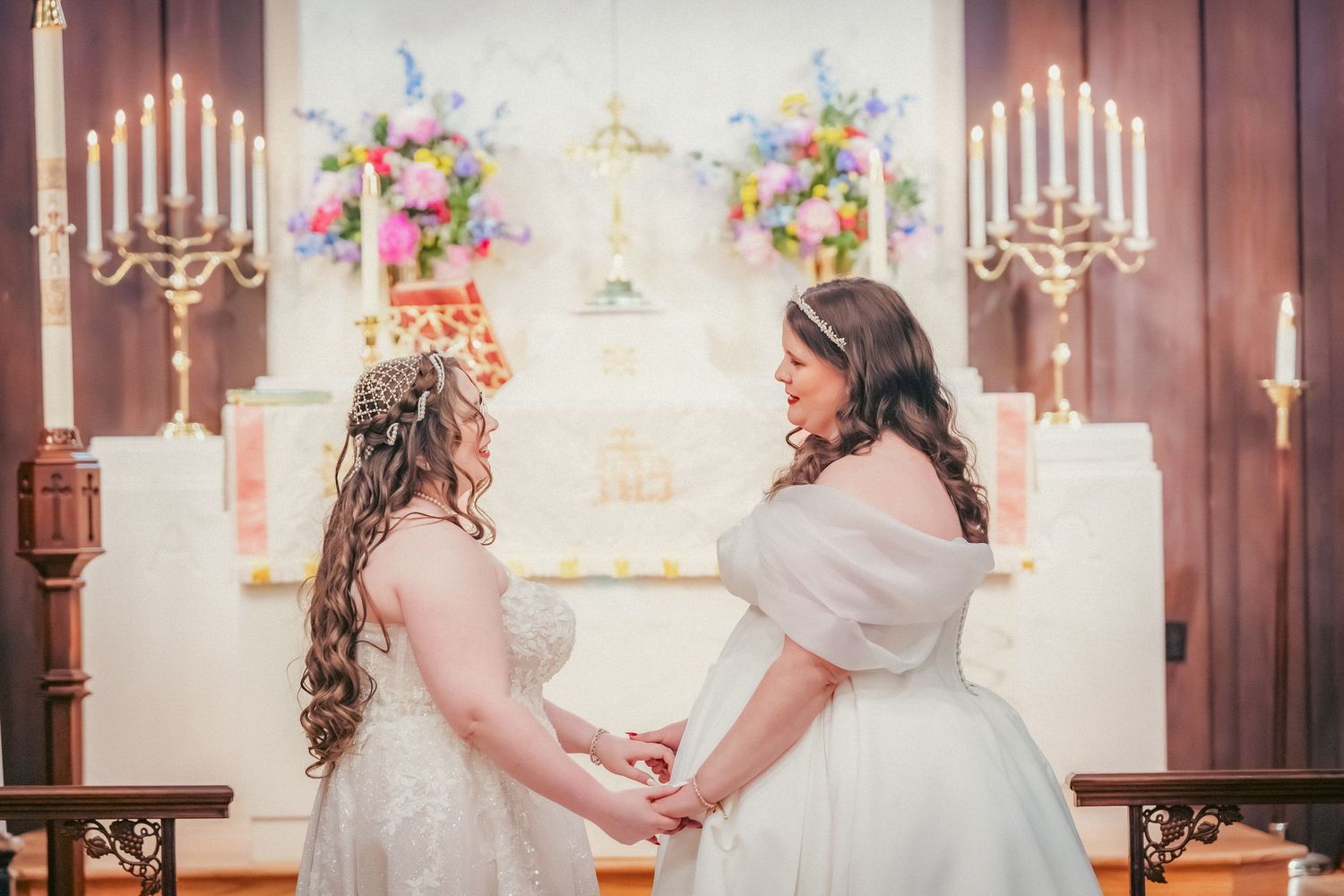 Wedding ceremony space with bright floral arrangements and white altar decorations.
