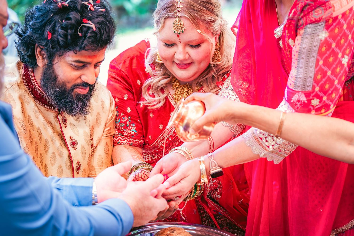 Wedding ceremony participants in traditional Indian attire during celebration.