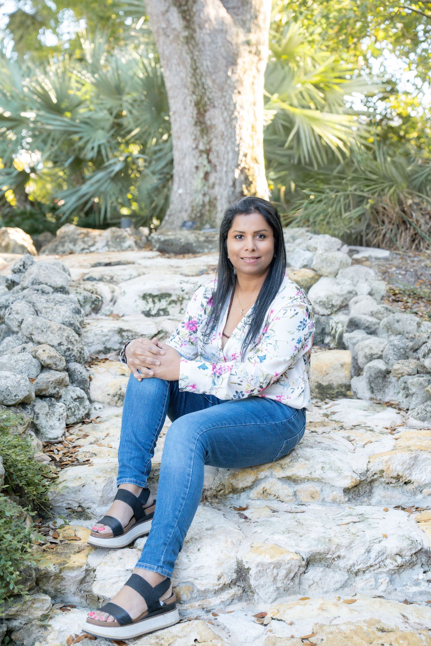 A series of outdoor portraits taken on rocky terrain with jeans and a floral top against a natural backdrop.