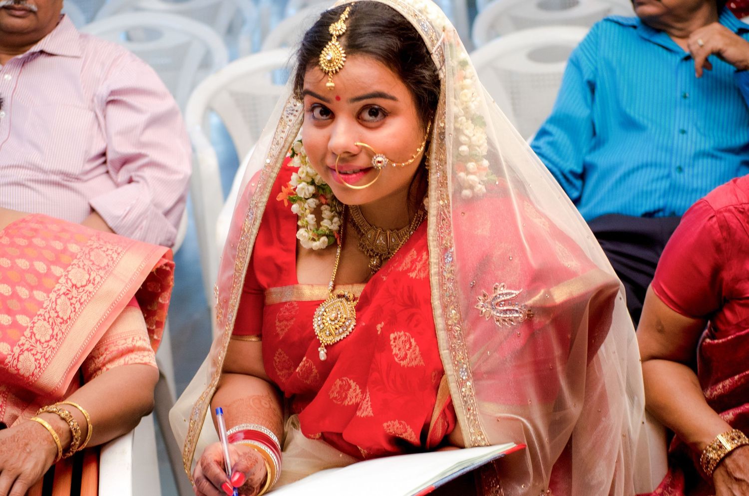 Traditional Indian wedding ceremony with guests in colorful attire.