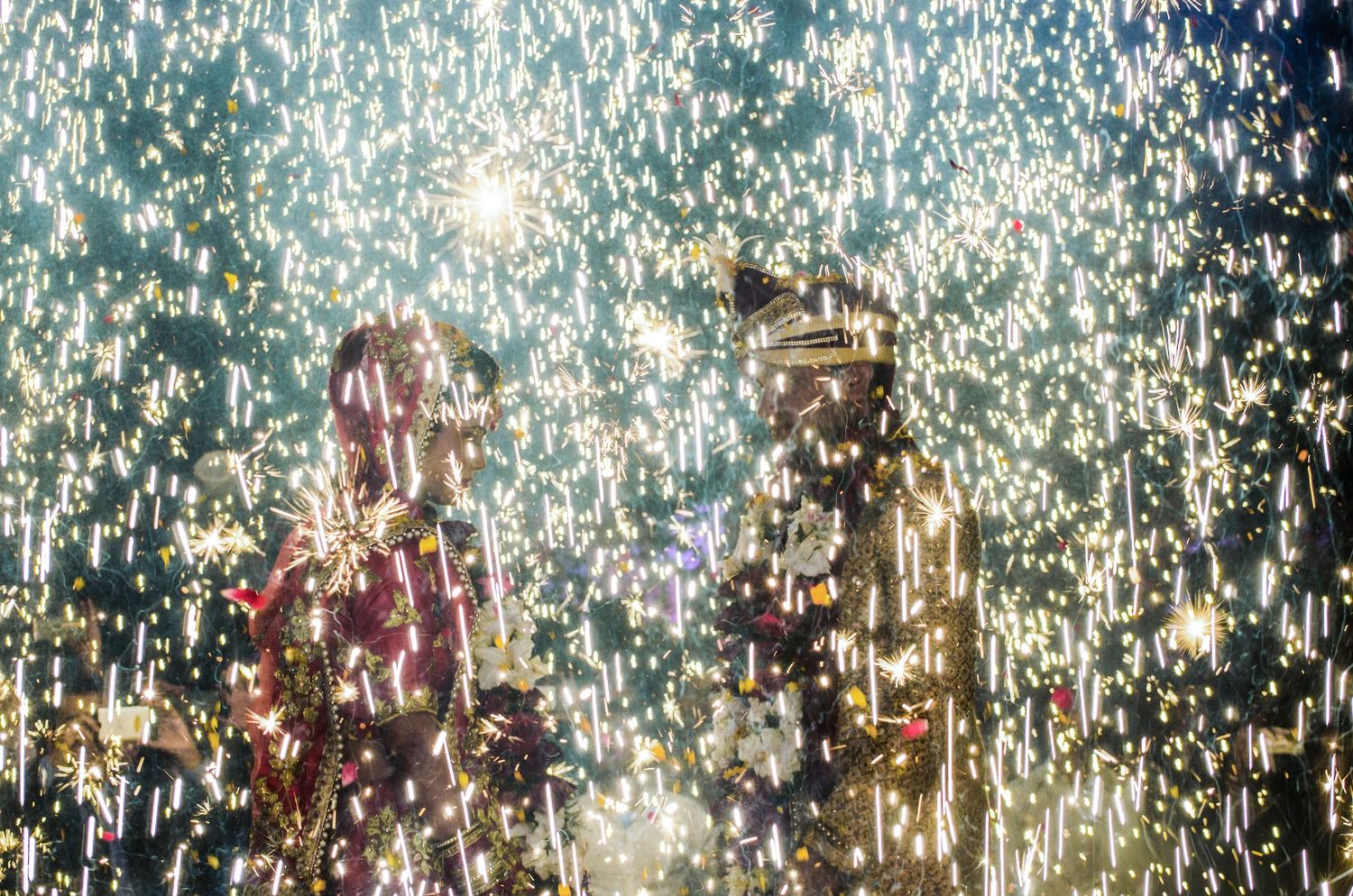 Sparkling fireworks display creating a magical backdrop for a wedding celebration.