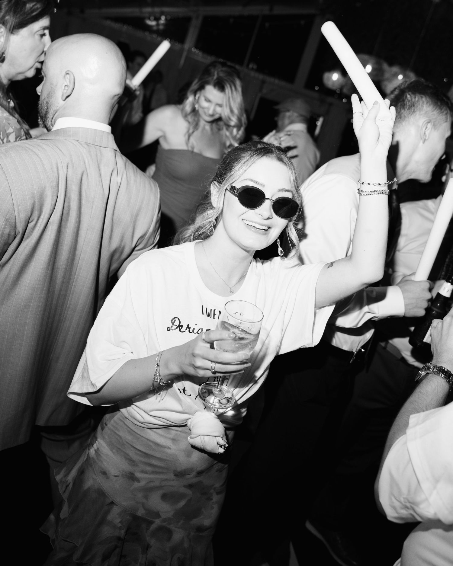 Black and white photo of energetic dance party with people celebrating.