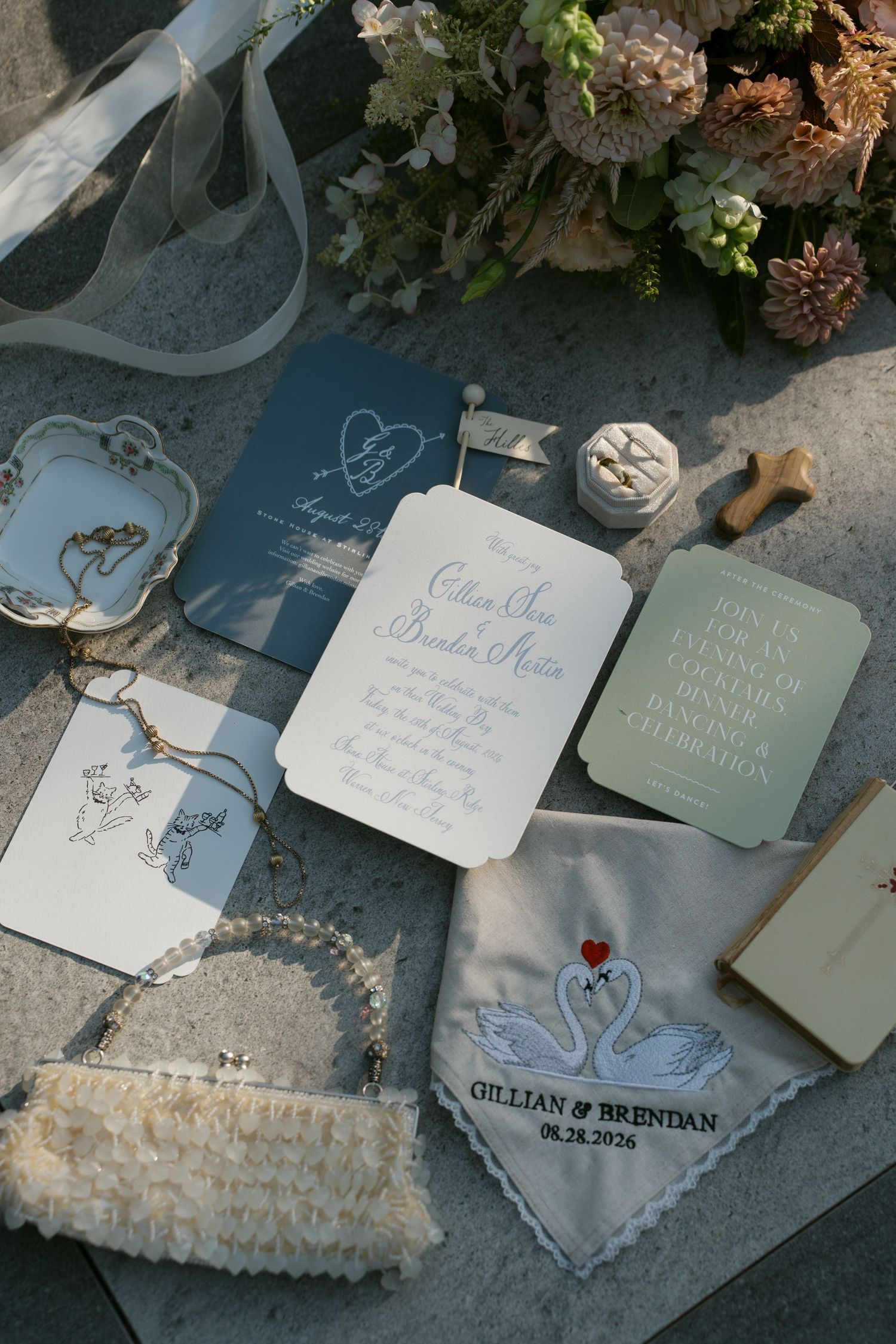 Elegant wedding stationery suite for Gillian and Brendan featuring blue and white invitations, swan handkerchief, and floral details.