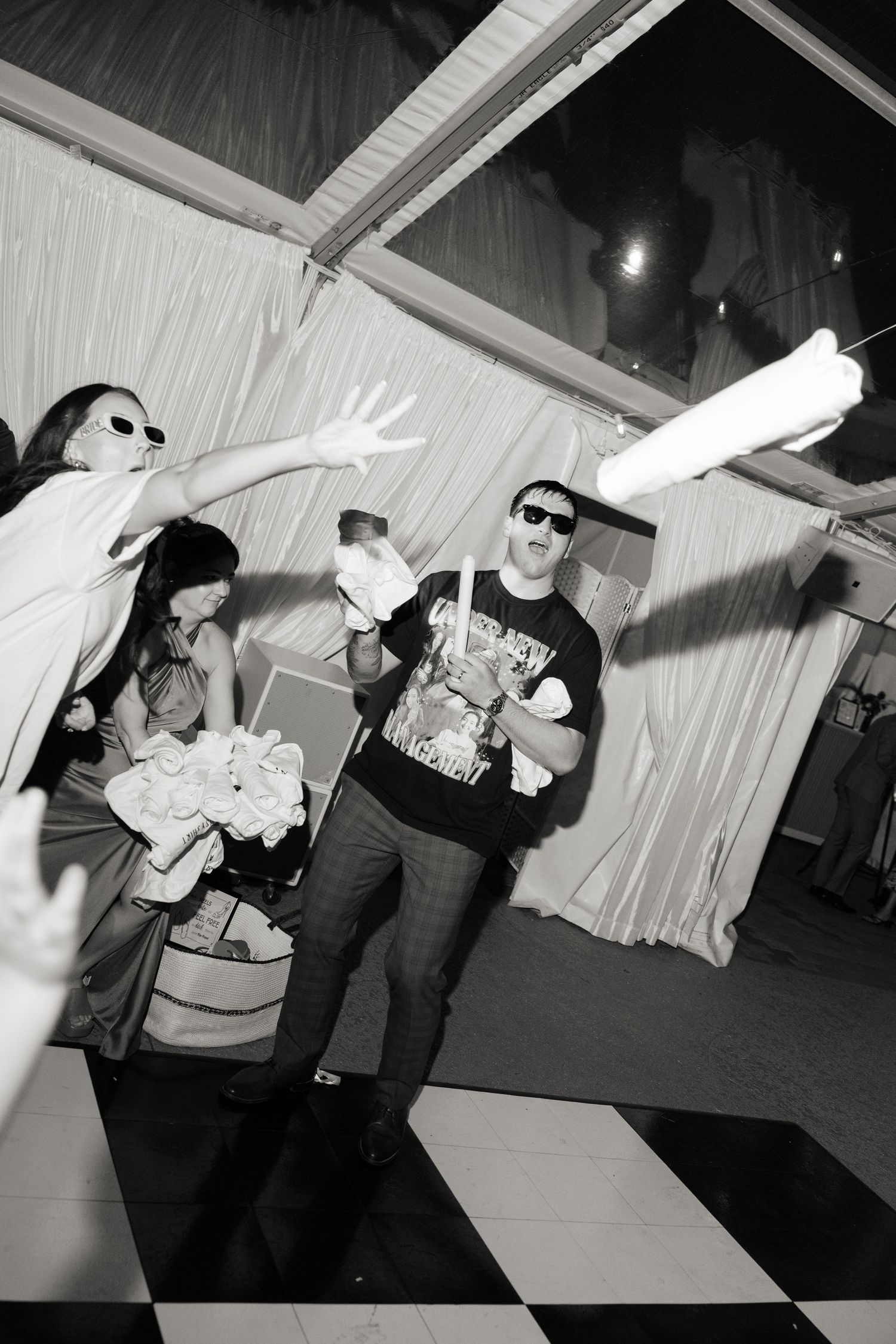 Black and white photos of wedding guests dancing at reception.