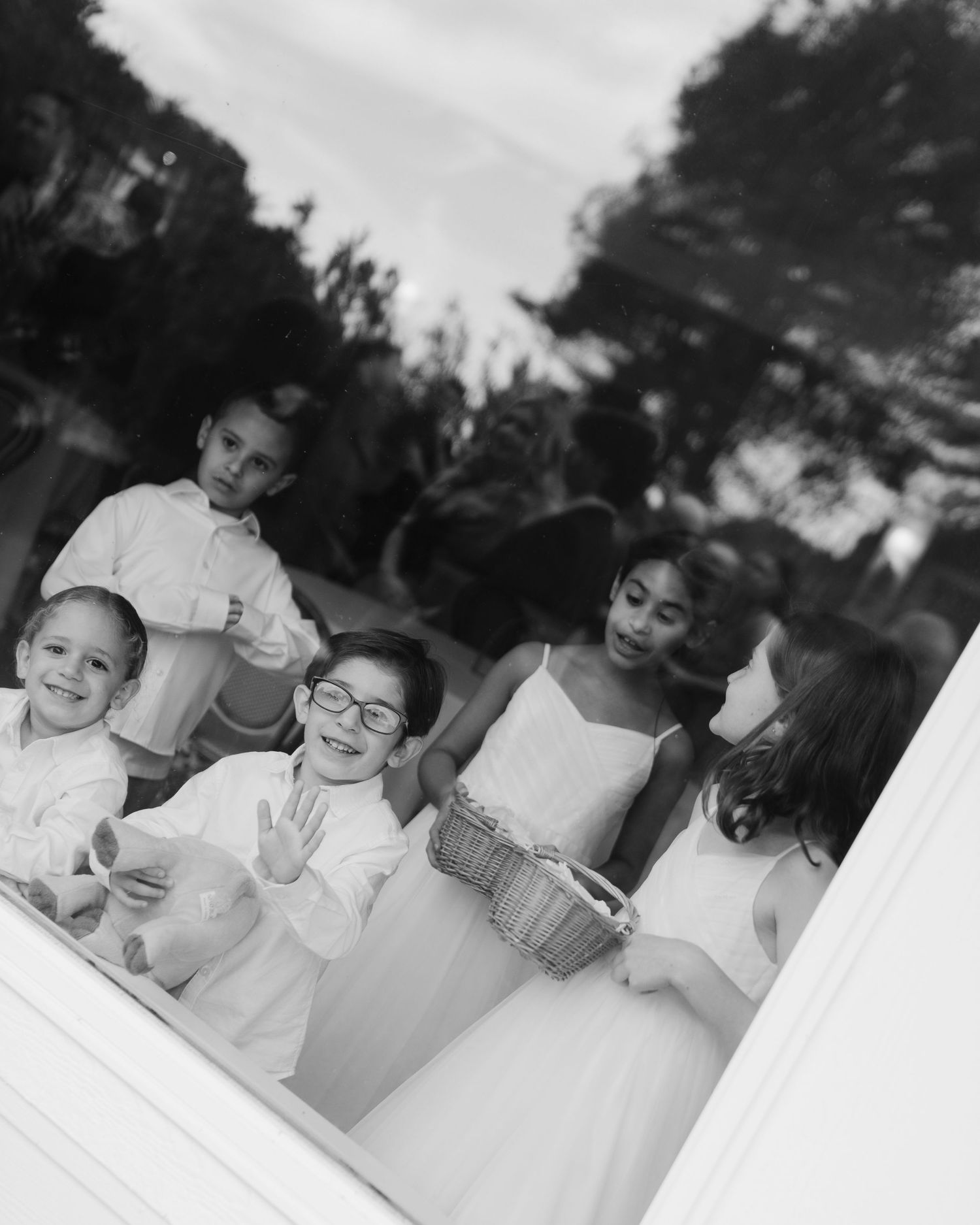 A black and white panoramic sequence shows students sitting at desks and working on an activity in a classroom setting.