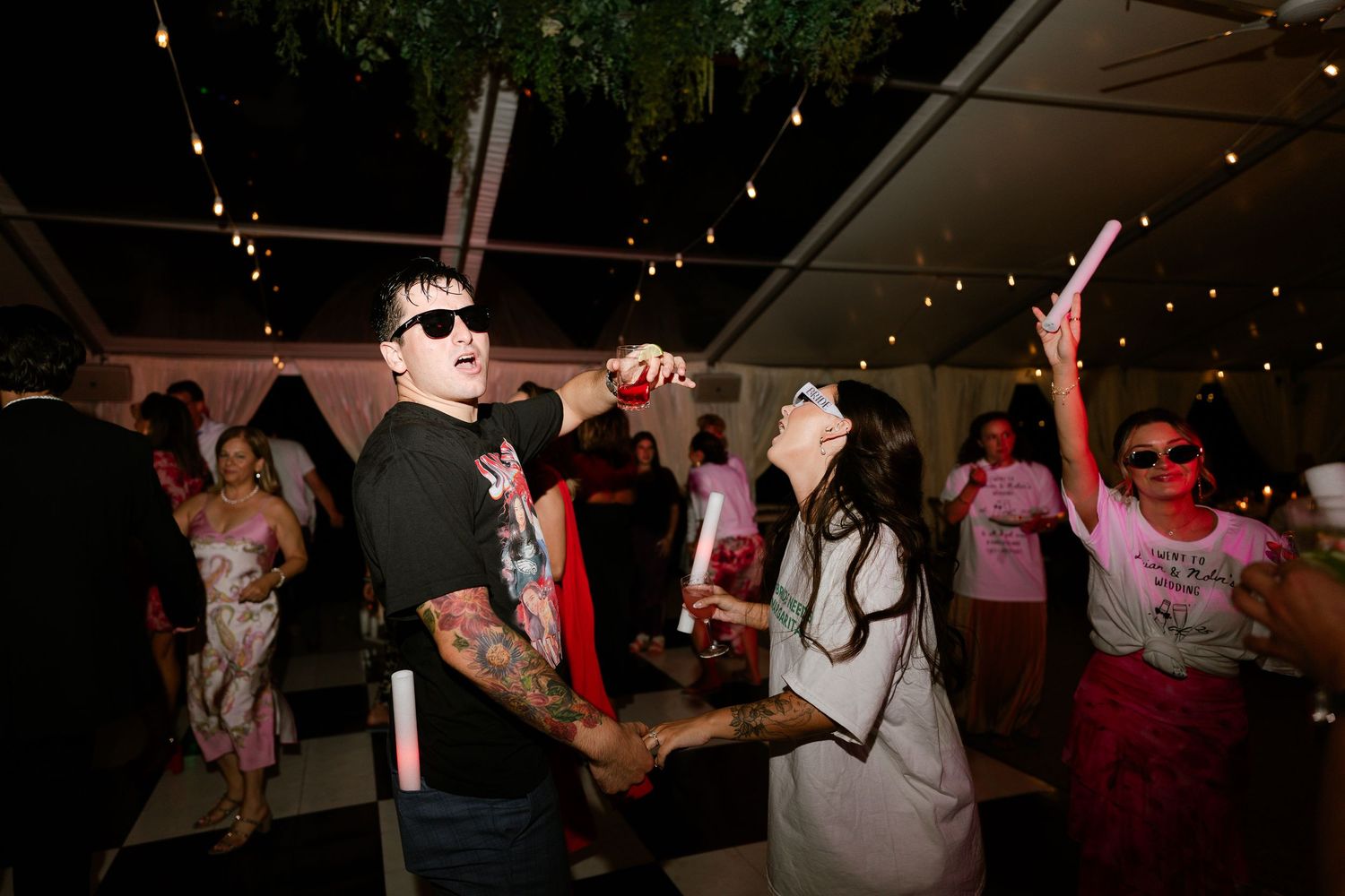 Lively dance floor moments captured during evening wedding reception celebrations.