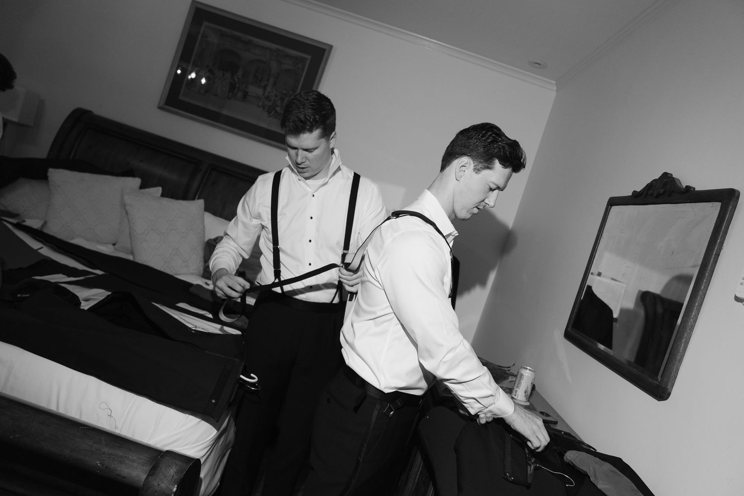 Black and white photo of wedding preparations in a dimly lit room.