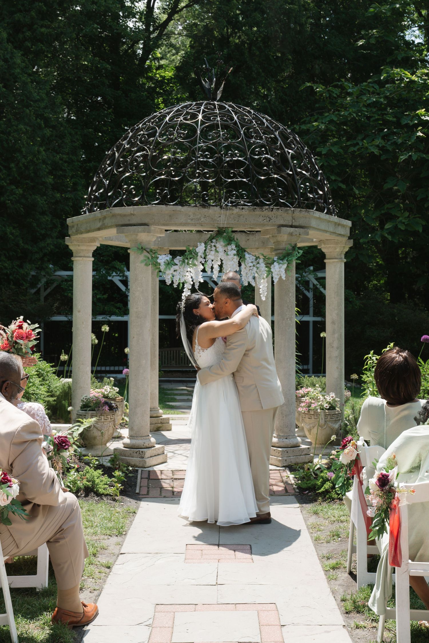 A wedding ceremony sequence in a garden gazebo with white columns and floral decorations captured in multiple frames.