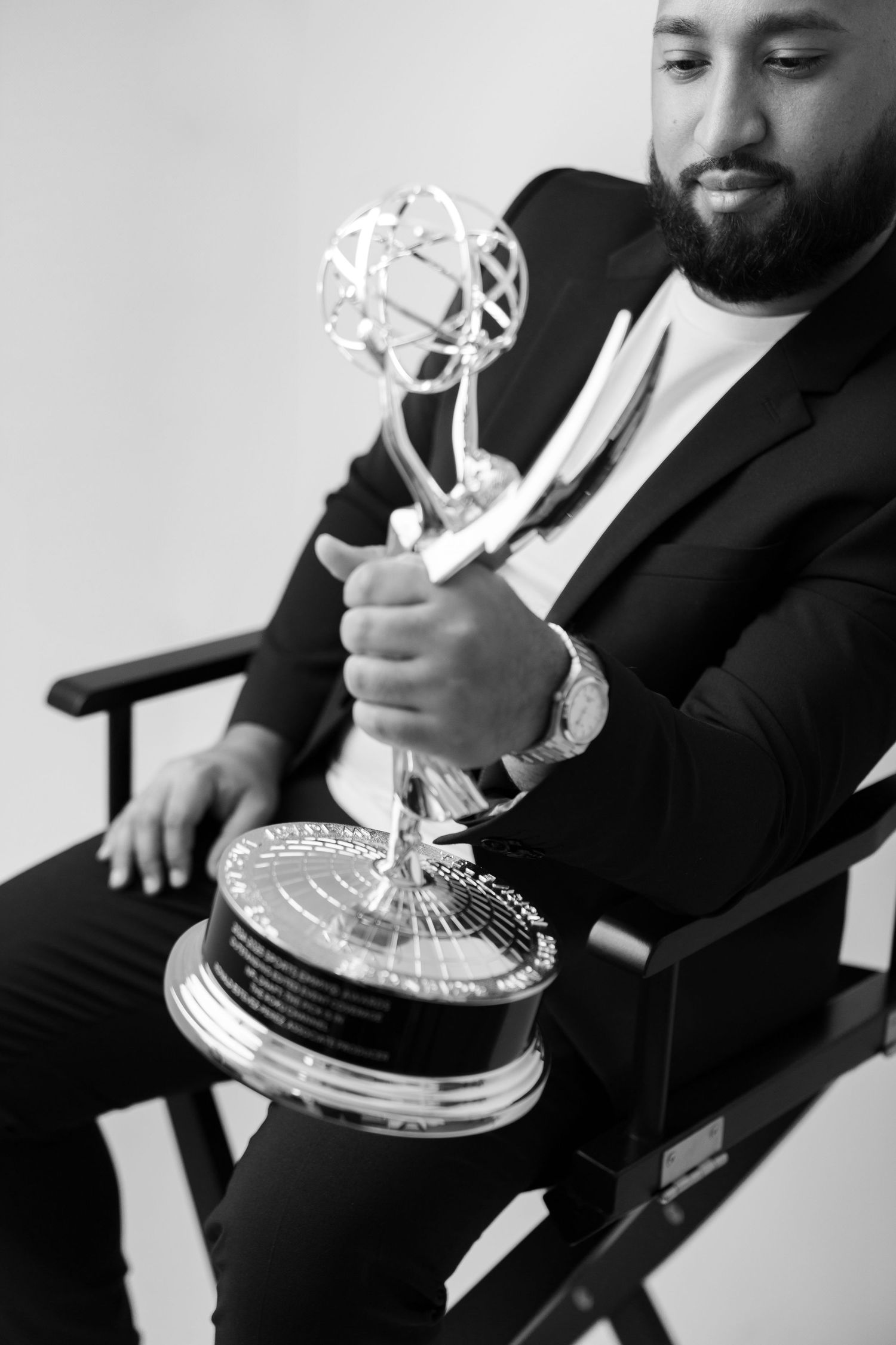 Black and white photos of Emmy award trophy being displayed.