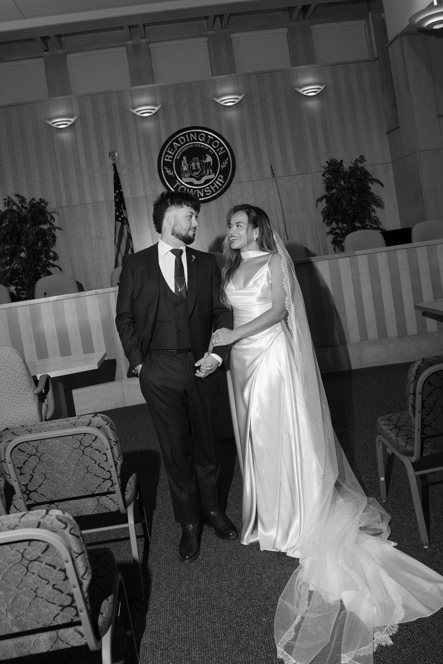 Black and white photo of newlyweds sharing a loving glance at Readington Township hall.