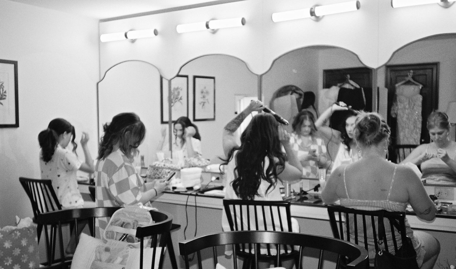 A busy Chinese restaurant dining room shows customers seated at tables while servers assist during service hours.