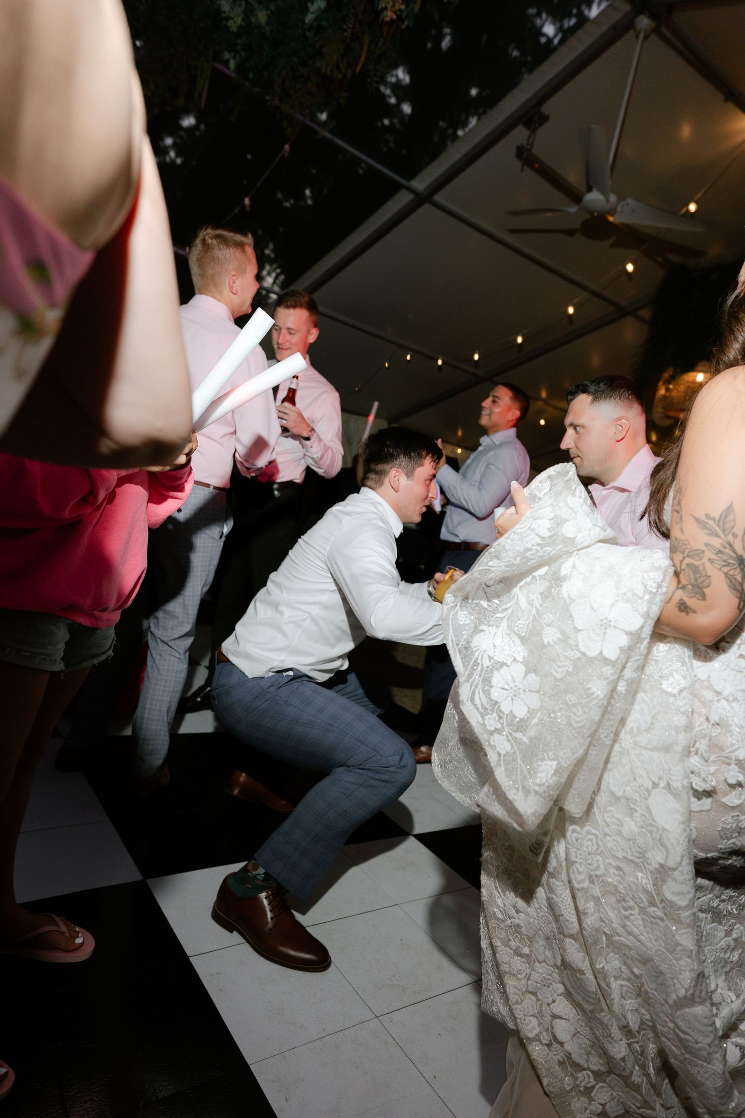 Wedding reception dance floor with guests dancing and celebrating.