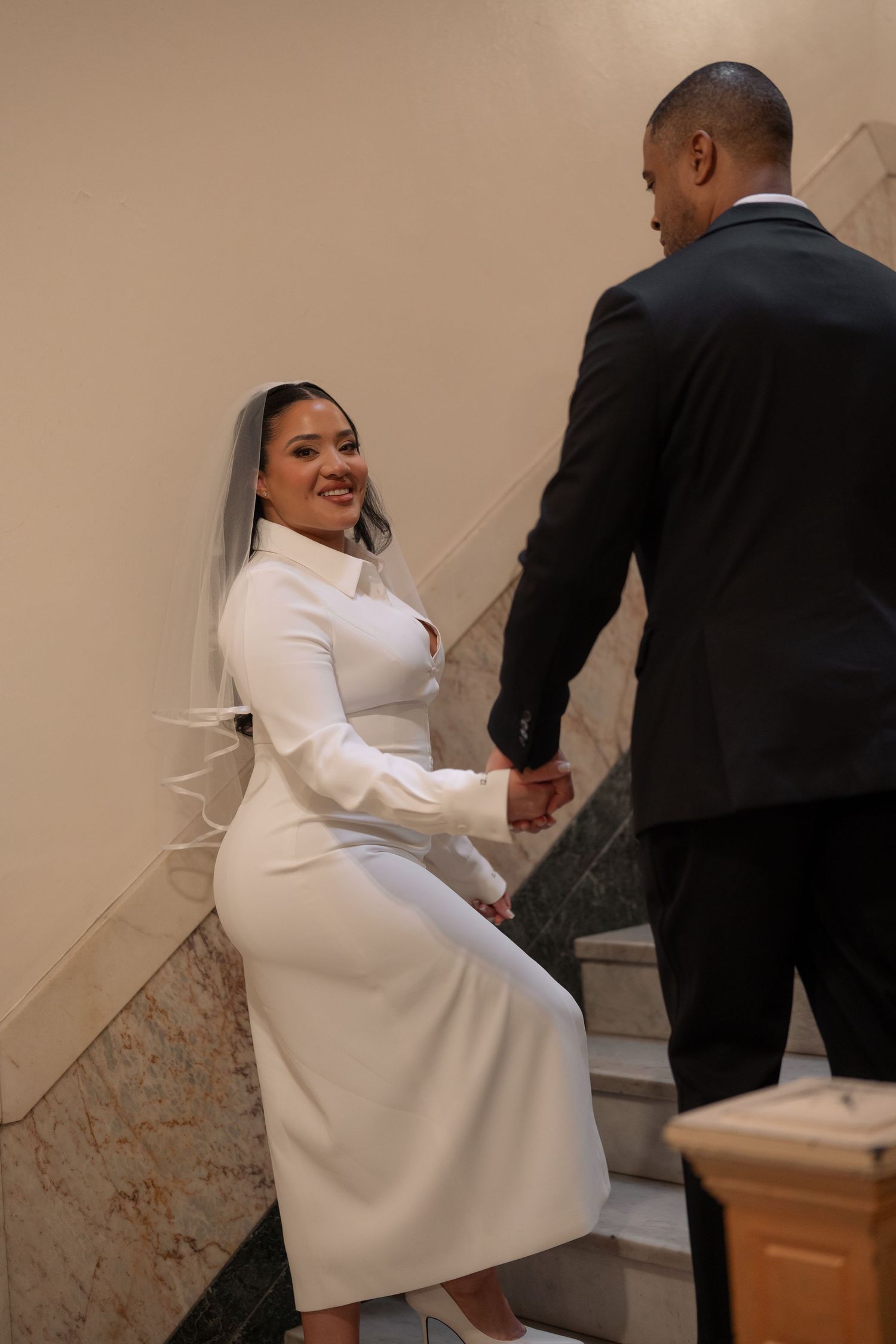 Series of shots showing a couple walking up elegant marble stairs.