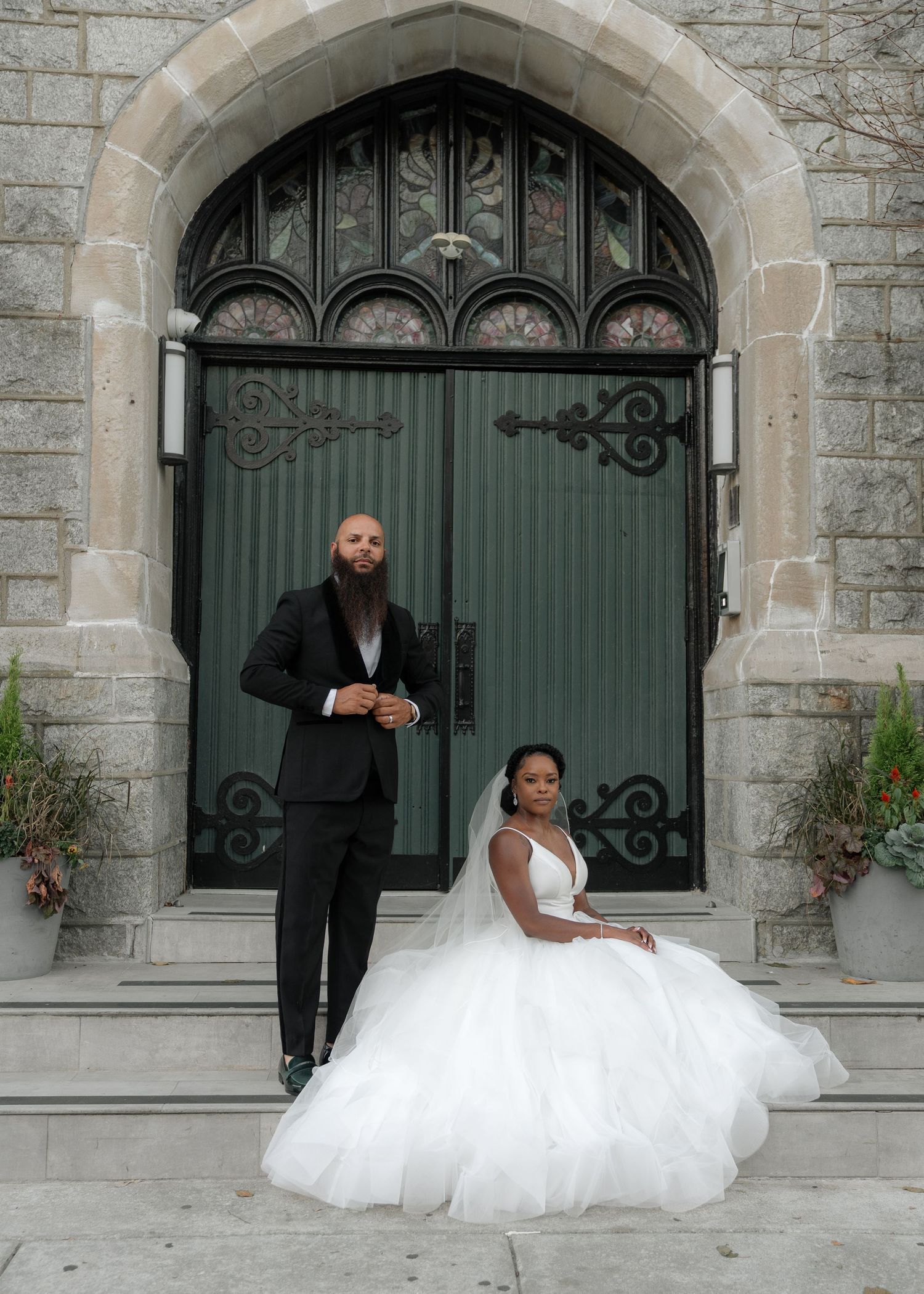 A wedding photoshoot sequence outside a gothic stone church with green doors.