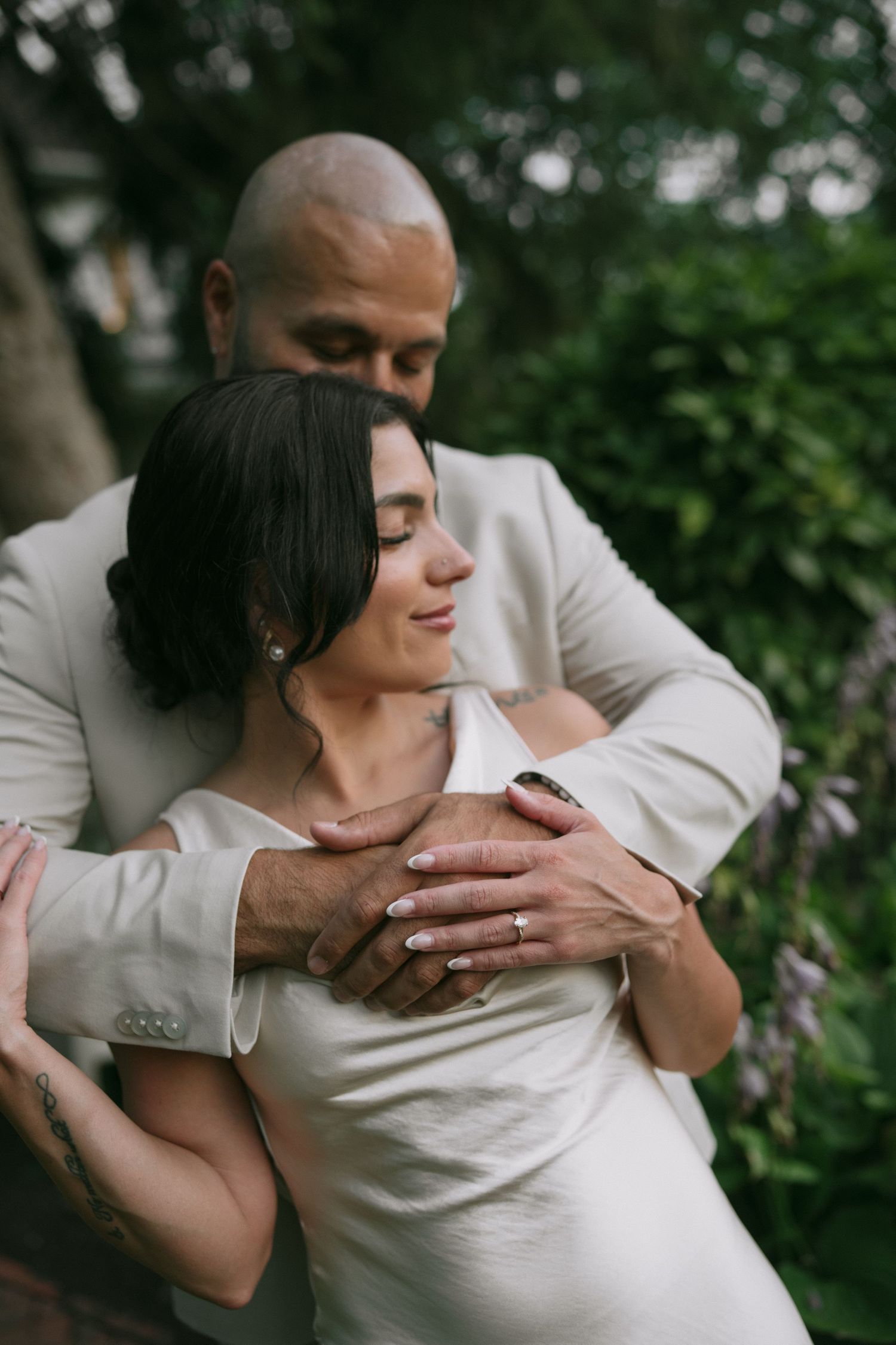 Intimate portrait sequence of couple embracing in formal attire against greenery.