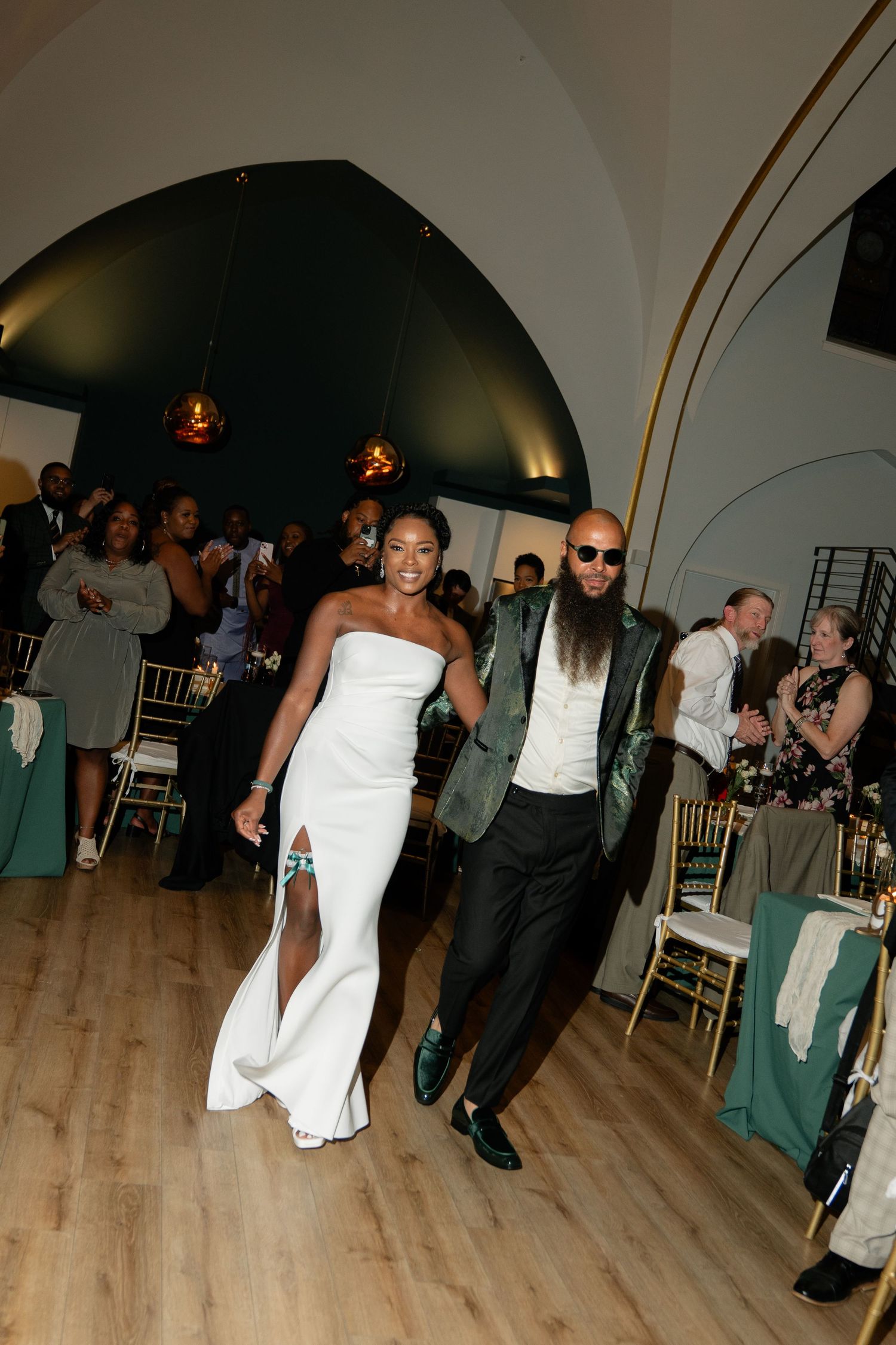 Wedding reception dance floor with guests celebrating in formal attire.