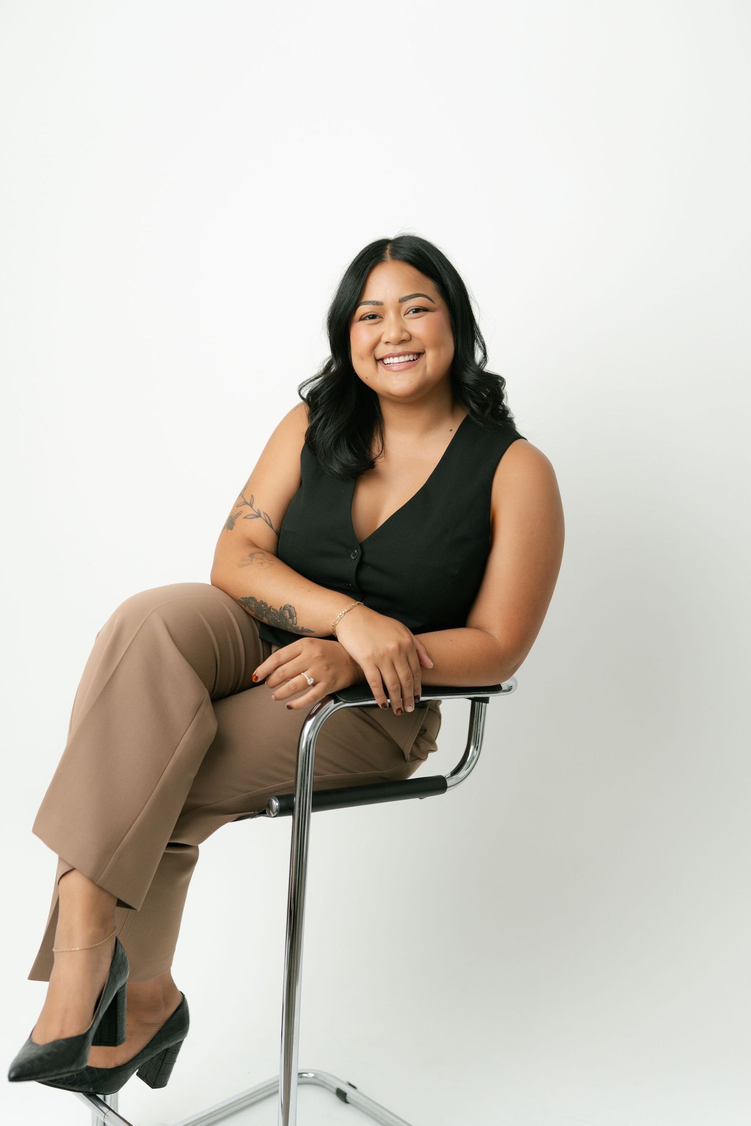 Relaxed studio portraits showing comfortable poses in a chair against white background.