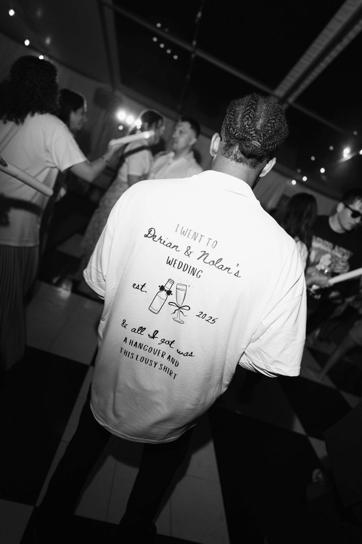 Black and white photos of custom printed t-shirts with Chinese characters and text displayed at an event.