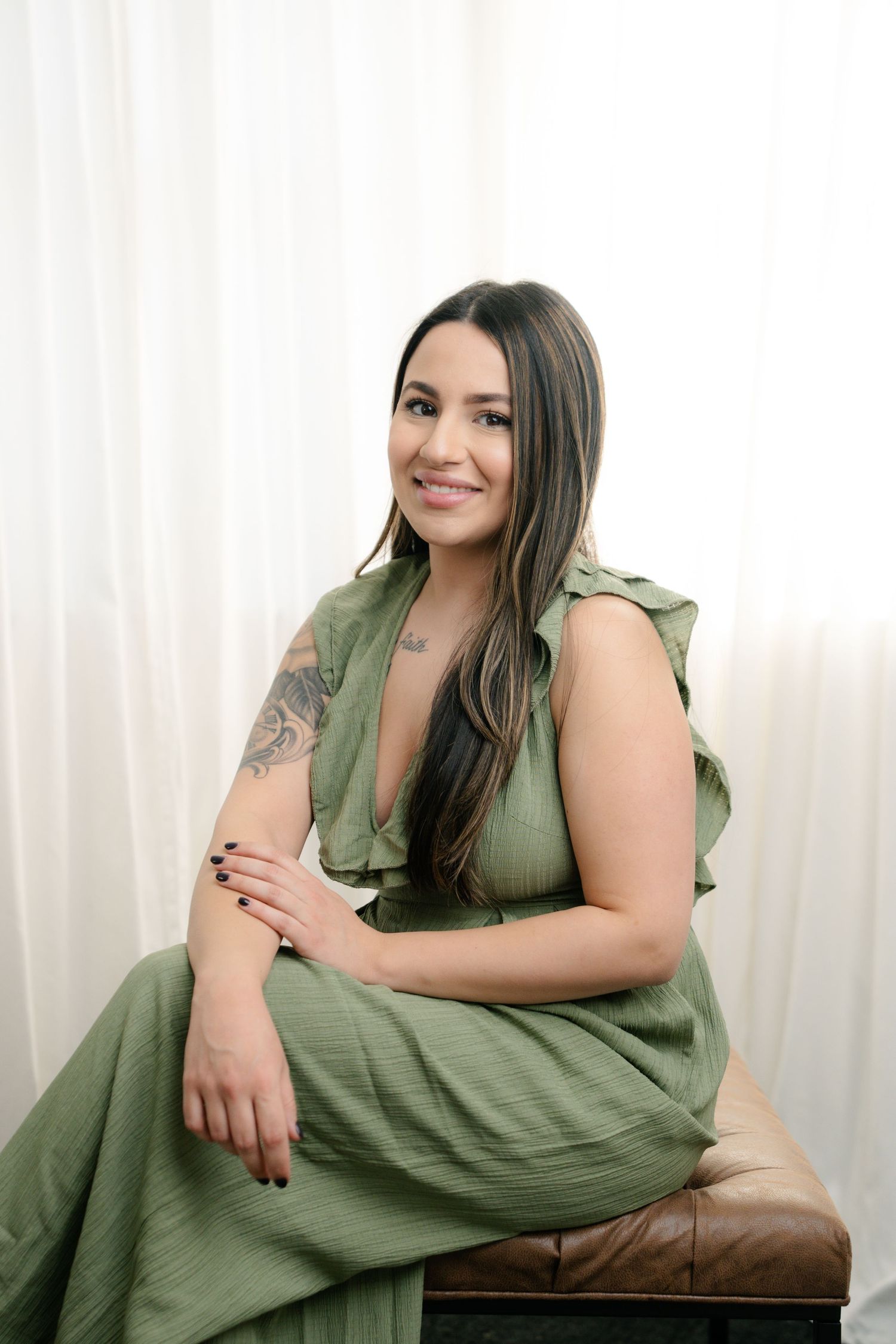 Portrait series showing poses in an olive green dress against a white backdrop with curtains.