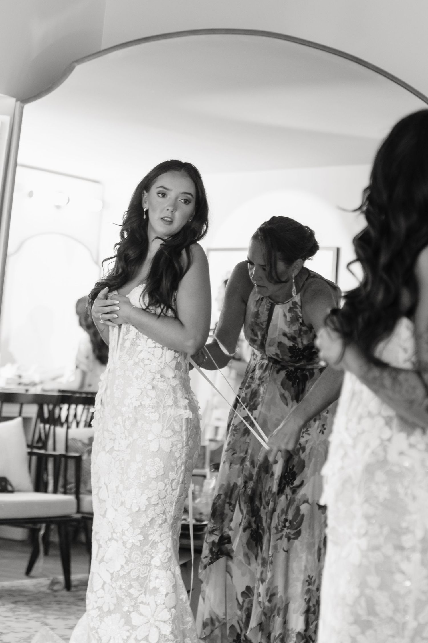 A series of candid moments showing a bride in a white lace dress getting ready on her wedding day.