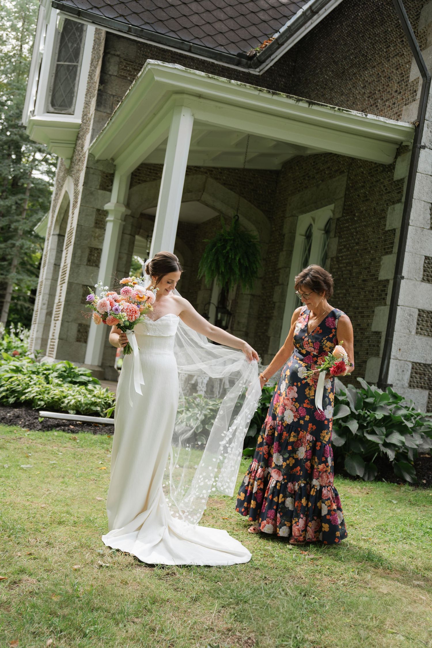 A series of four photos showing two people in floral dresses playing and dancing together on a porch of a house.