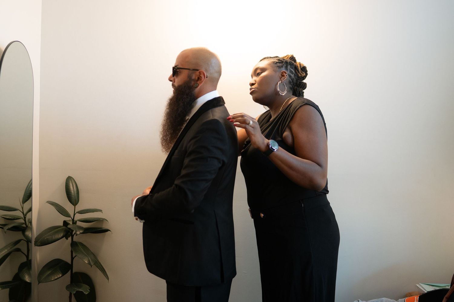 Two people engaged in conversation in a bright white room.