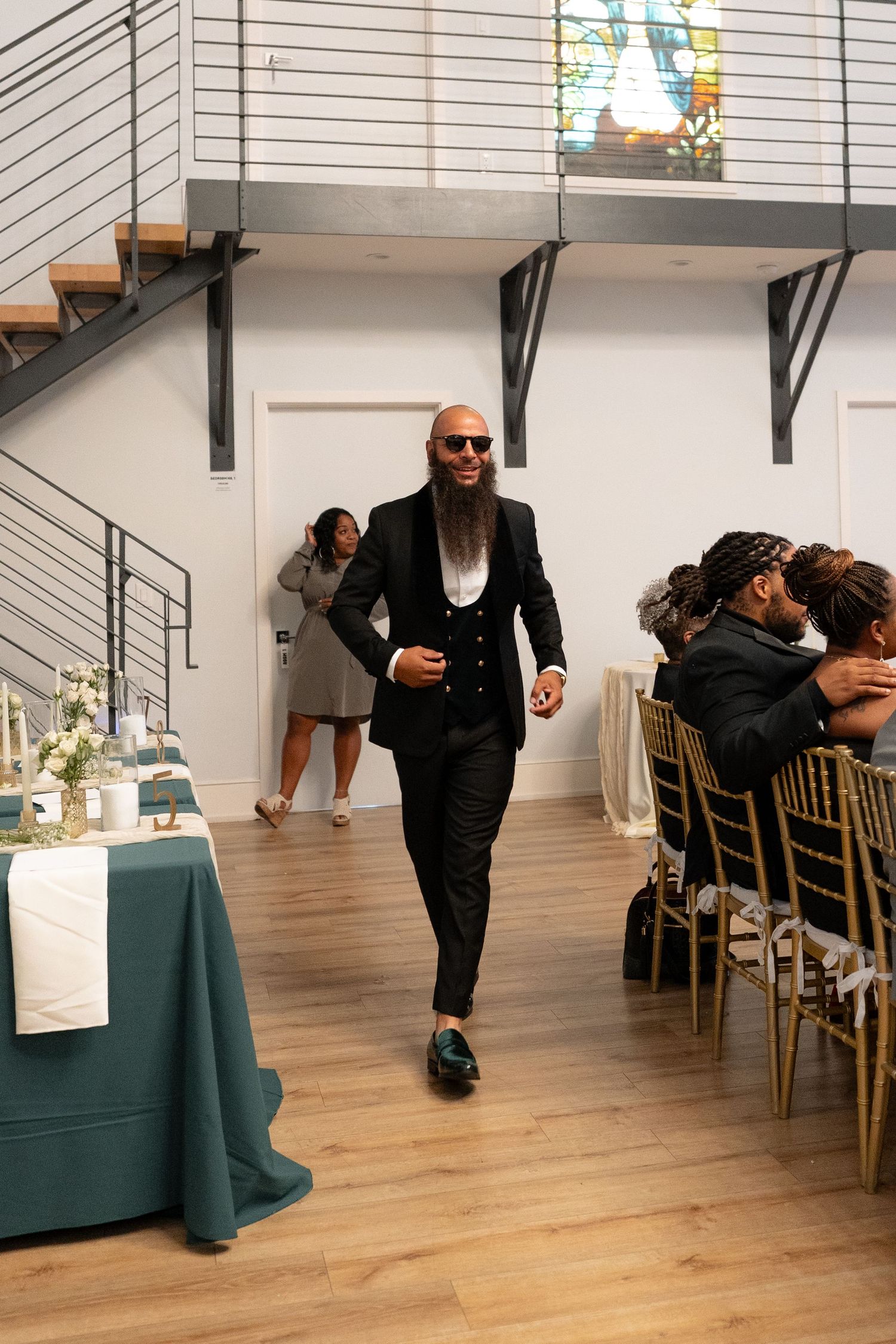A sequence showing playful dance moves across a modern reception venue with teal tablecloths.