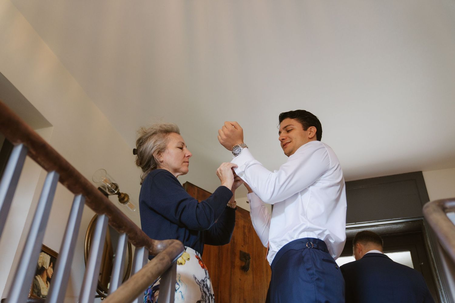Two people practicing a dance routine together in a home setting.