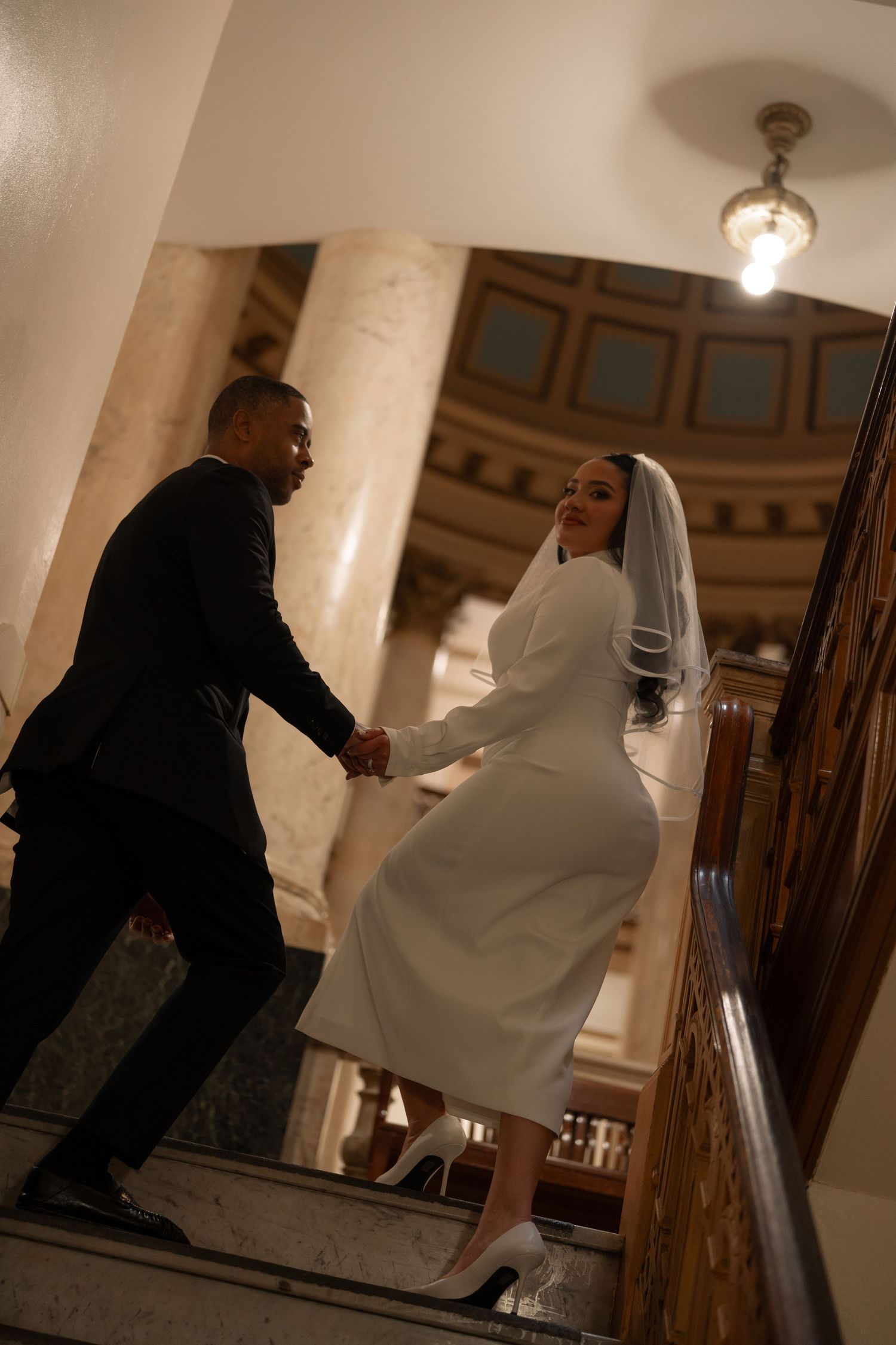Sequence of wedding photos on stairs showing couple in dramatic lighting and poses.