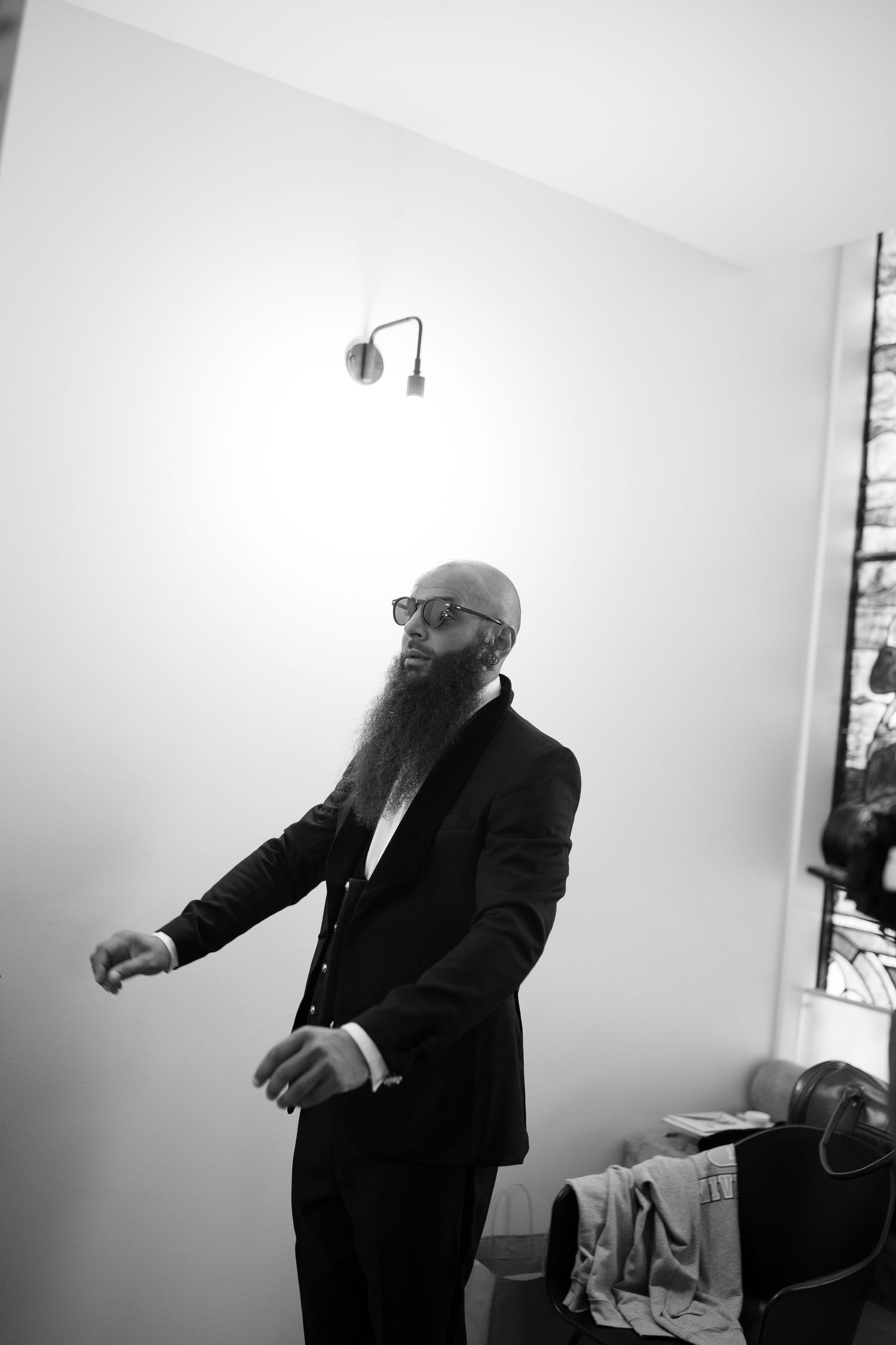 Dynamic black and white shots of movement in a minimalist white room.