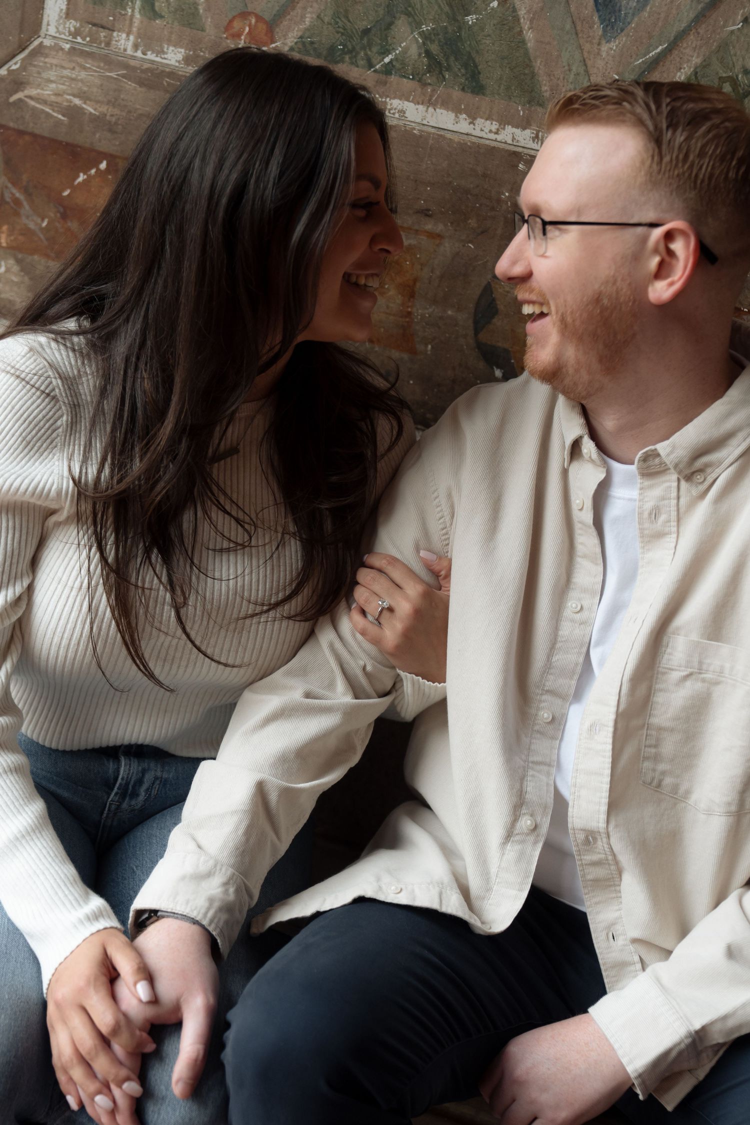 Couple sharing an intimate moment while sitting together indoors.