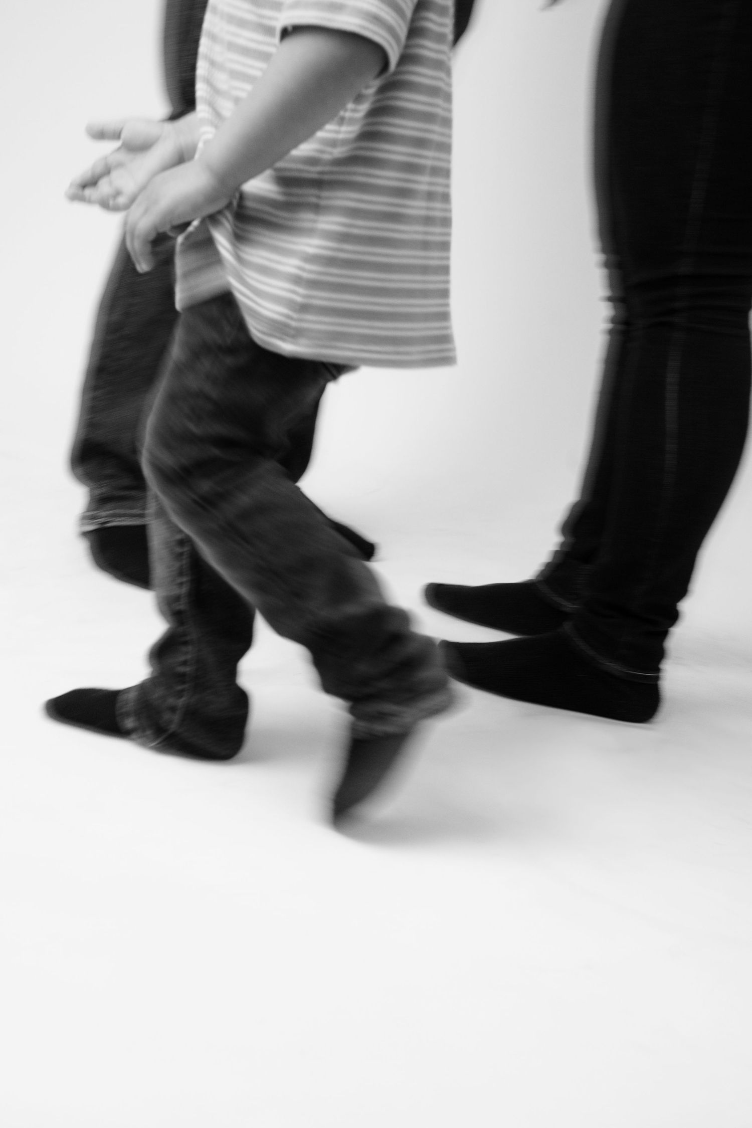 Abstract motion blur photography of people walking in black and white.