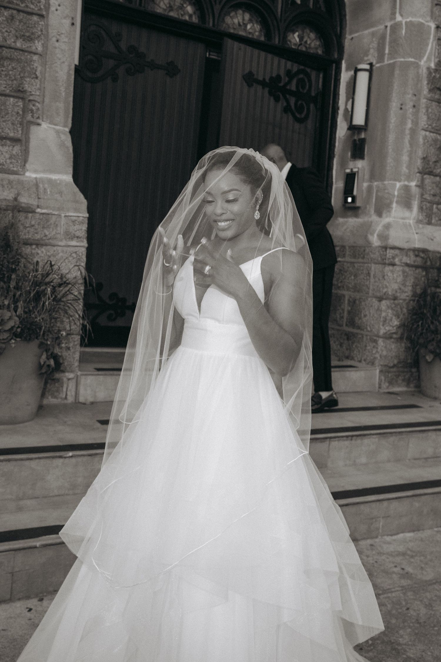 A sequence showing flowing movements of a white wedding dress against stone architecture.