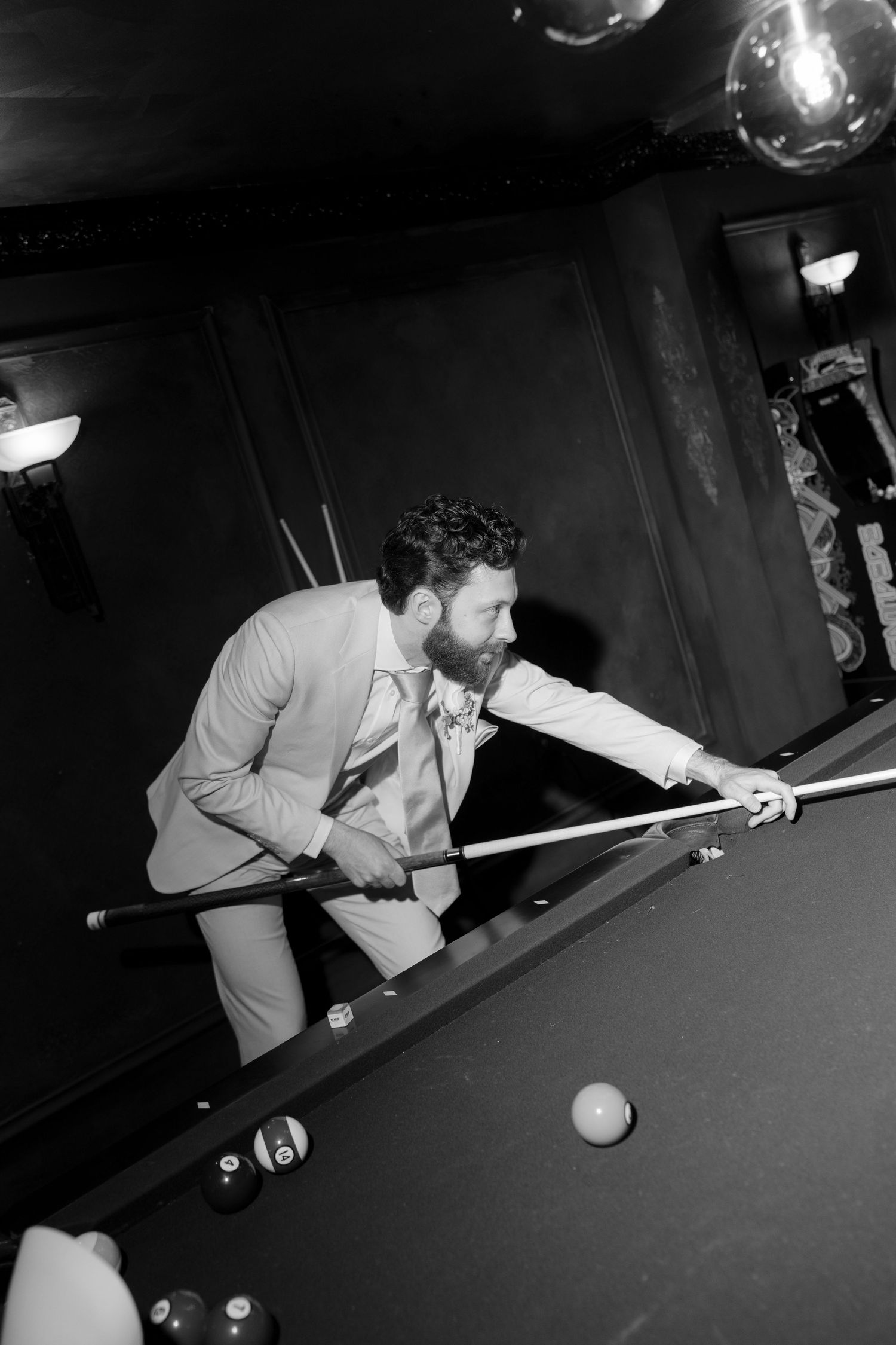 A sequence of black and white photos showing a player lining up and taking a shot at a billiards table.