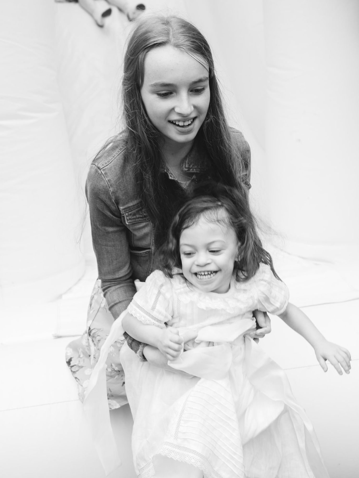 Black and white portrait session showing playful moments and genuine emotions.