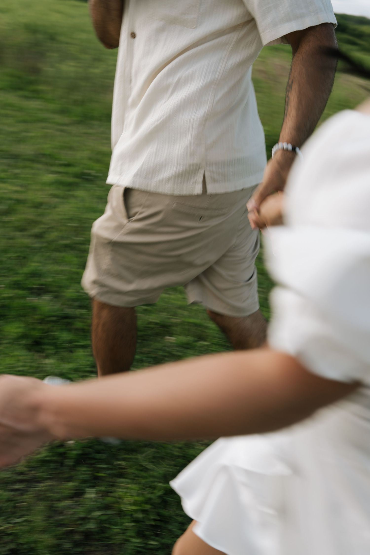 Sequence of photos showing couple in white and beige outfits walking together outdoors.