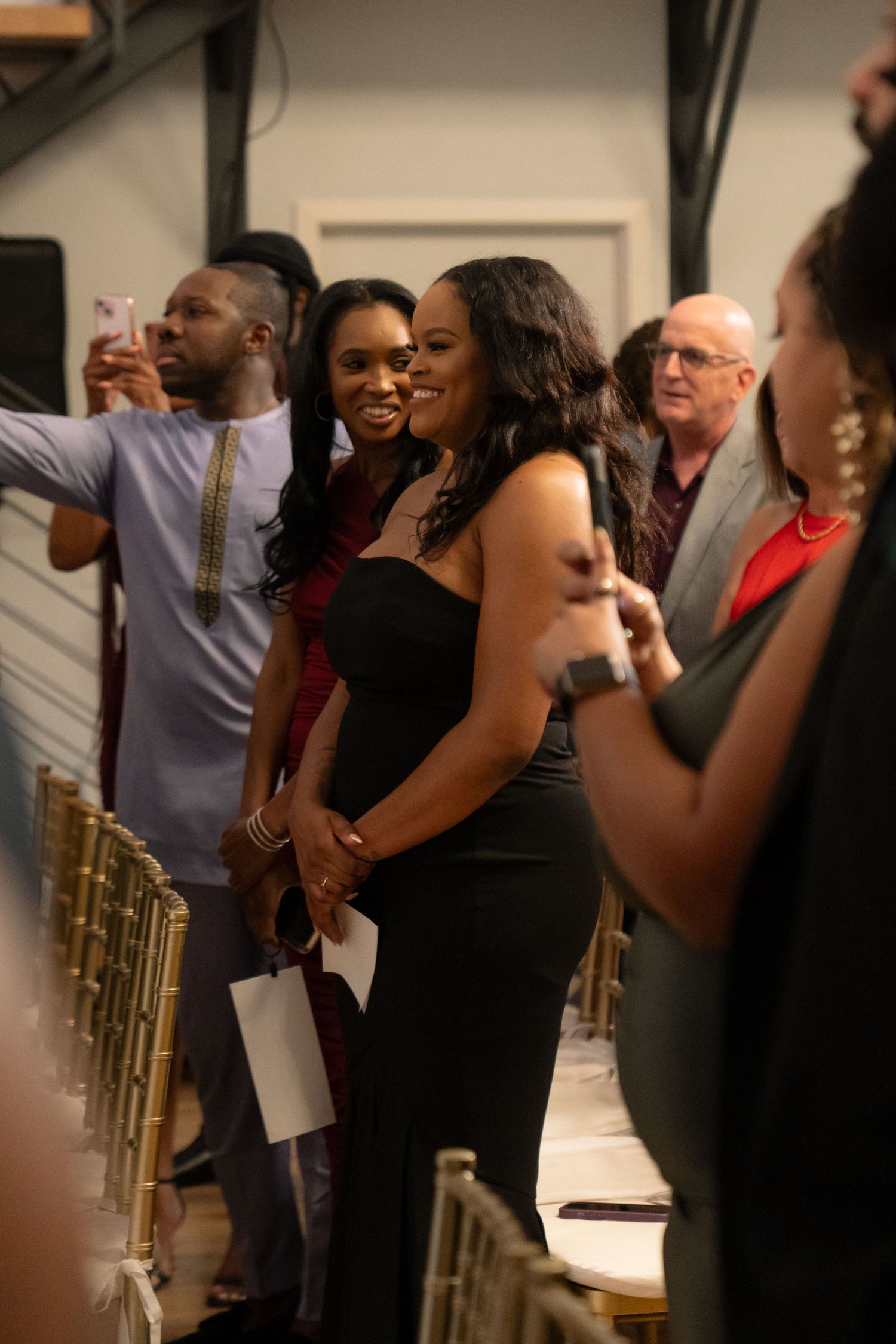 Wedding guests share joyful reactions during an emotional ceremony moment.