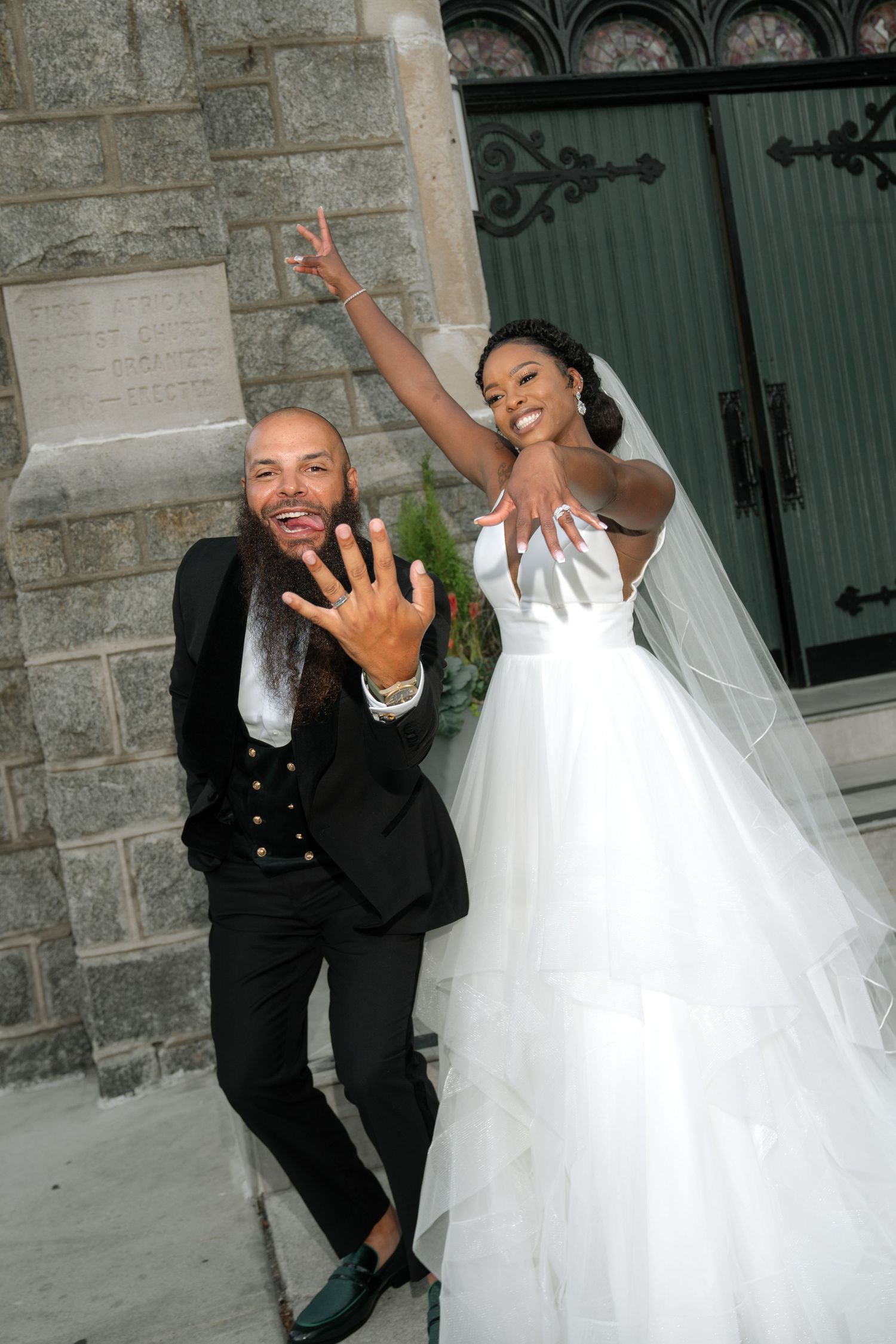 Playful wedding couple poses against stone wall exterior in series of fun candid shots.