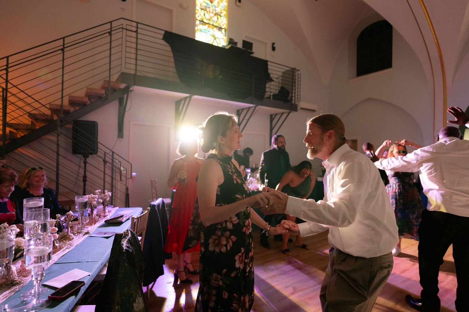 Wedding reception venue with vaulted ceilings and ambient lighting.