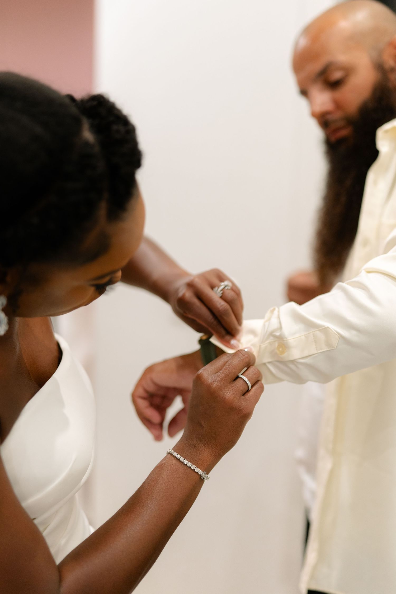 Close-up sequence showing hands exchanging rings during an intimate wedding ceremony.