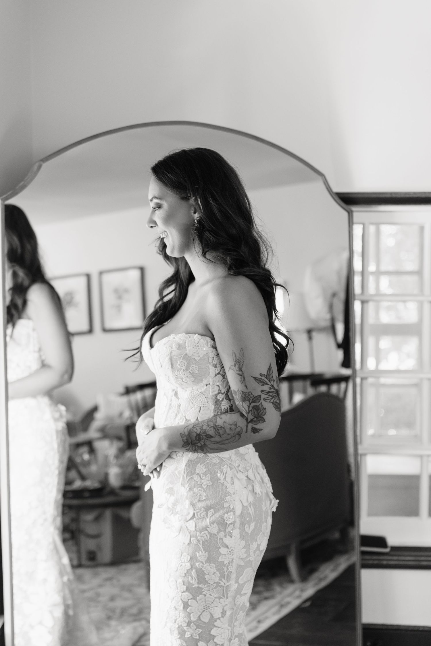 Elegant lace wedding dress captured in natural window light.
